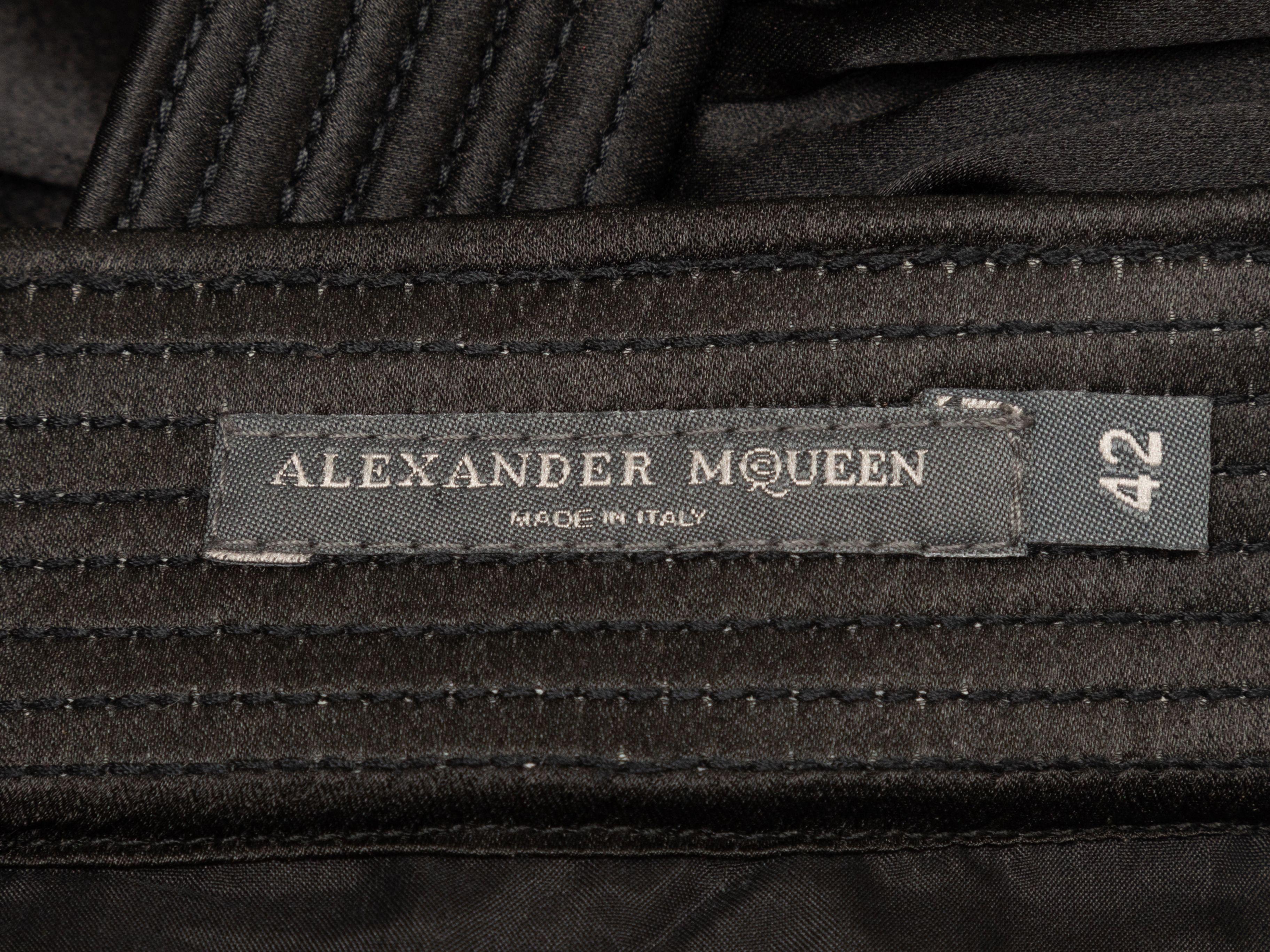 Product Details: Black silk pleated bubble hem skirt by Alexander McQueen. Circa 2007. Dual hip pockets. Designer size 42. 31