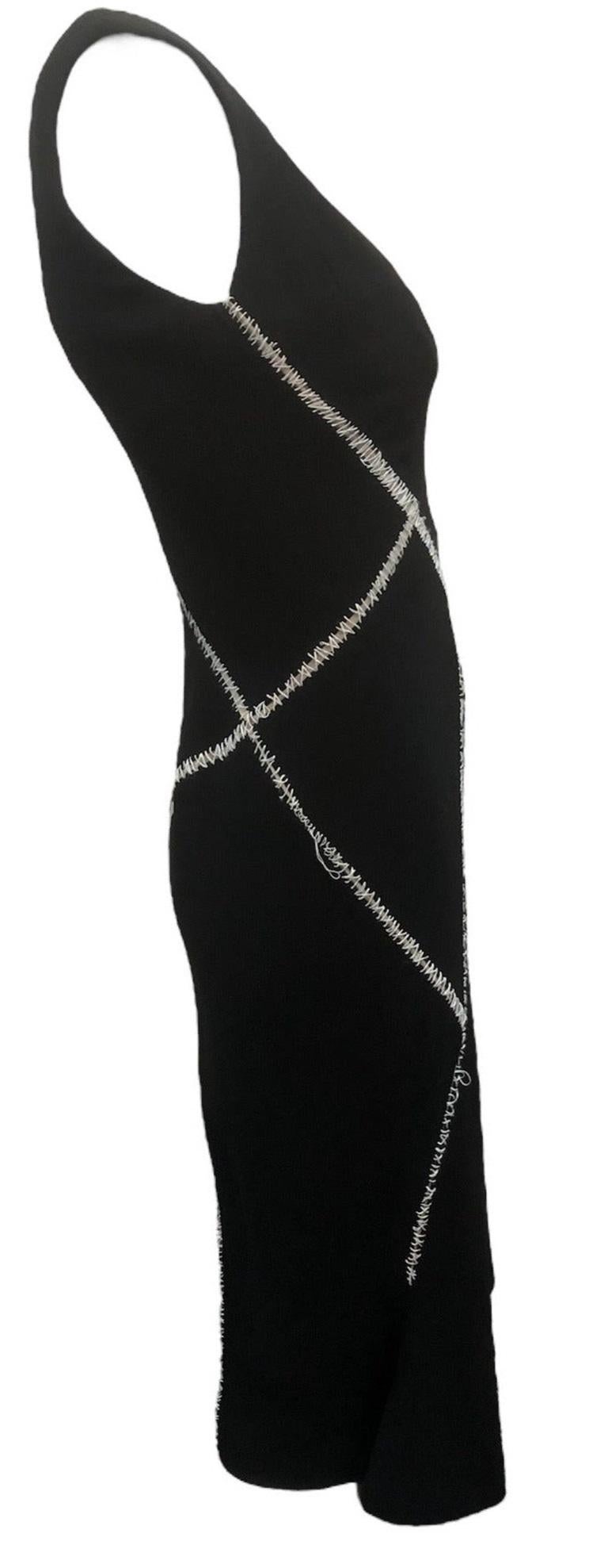From Alexander McQueen iconic 2004 Spring/Summer collection. Sexy sheath in black in a luxe wool/silk blend with a wee bit of spandex. Built in corselet - fully lined. Stitched all over in contrasting white Surgical style stitching.

Elegant, quirky