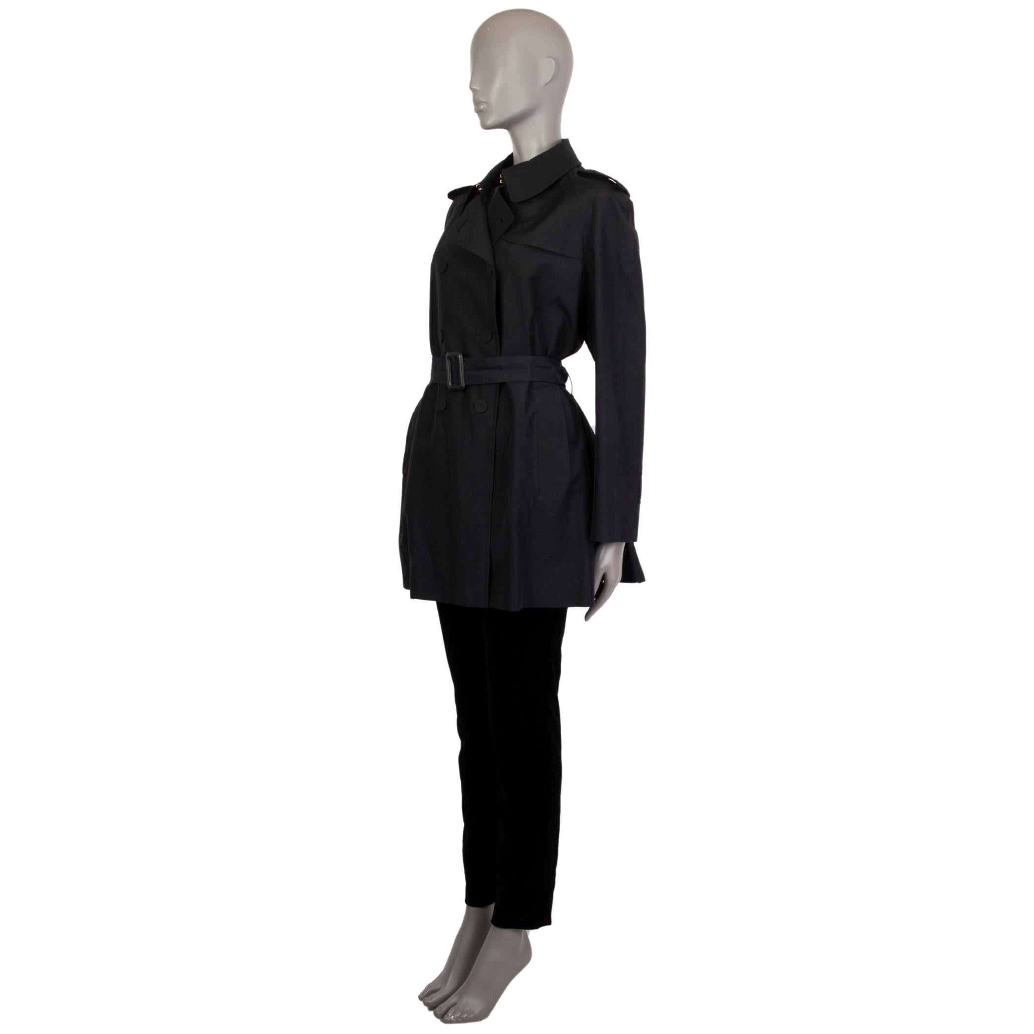 Alexander McQueen double-breasted trench coat in silk (52%) and cotton (48%). With epaulettes, storm flap on the left chest, box-pleated flap on the back, belt loops around the waist and cuffs, belted cuffs, two pockets on the sides, and pleated