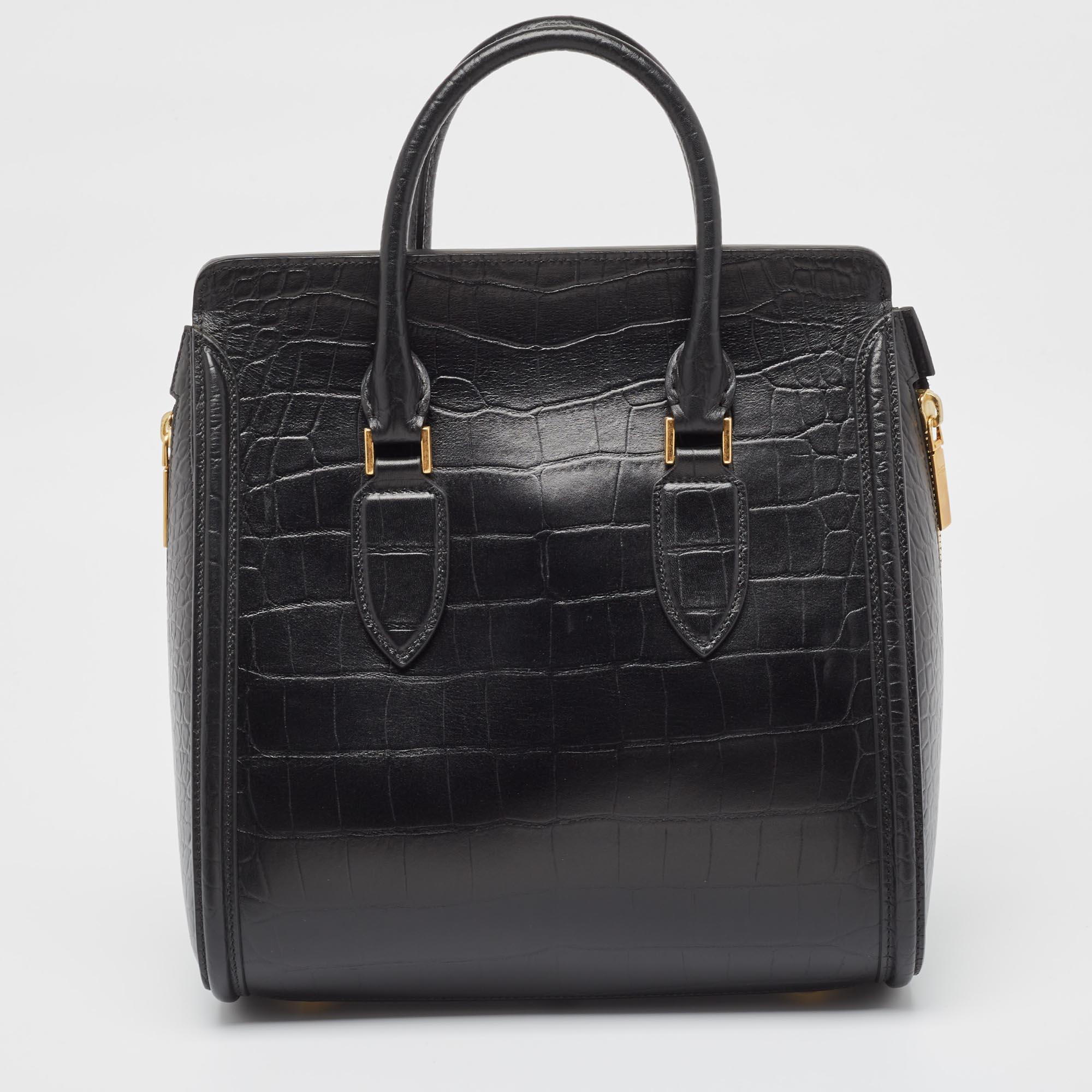 A sturdy fine leather body and double carry handles, the bag comes with a structured design and a flap closure for the main pocket. With gold-toned hardware to complement the sophisticated styling, it features a large pocket and a rigid base with