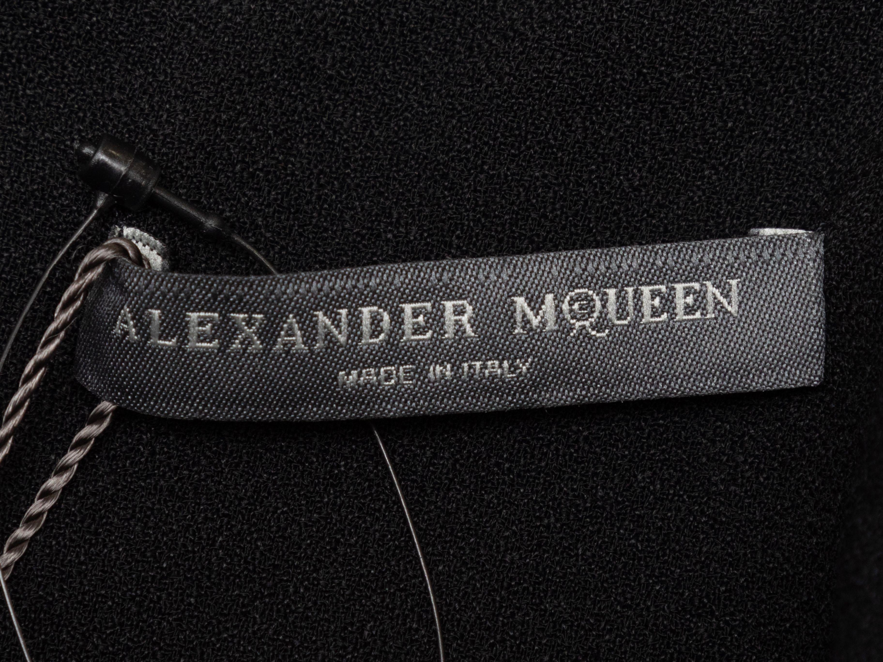 Product Details: Black short sleeve mini dress by Alexander McQueen. V-neck. Draping at skirt. Zip closure at back. Designer size 38. 26