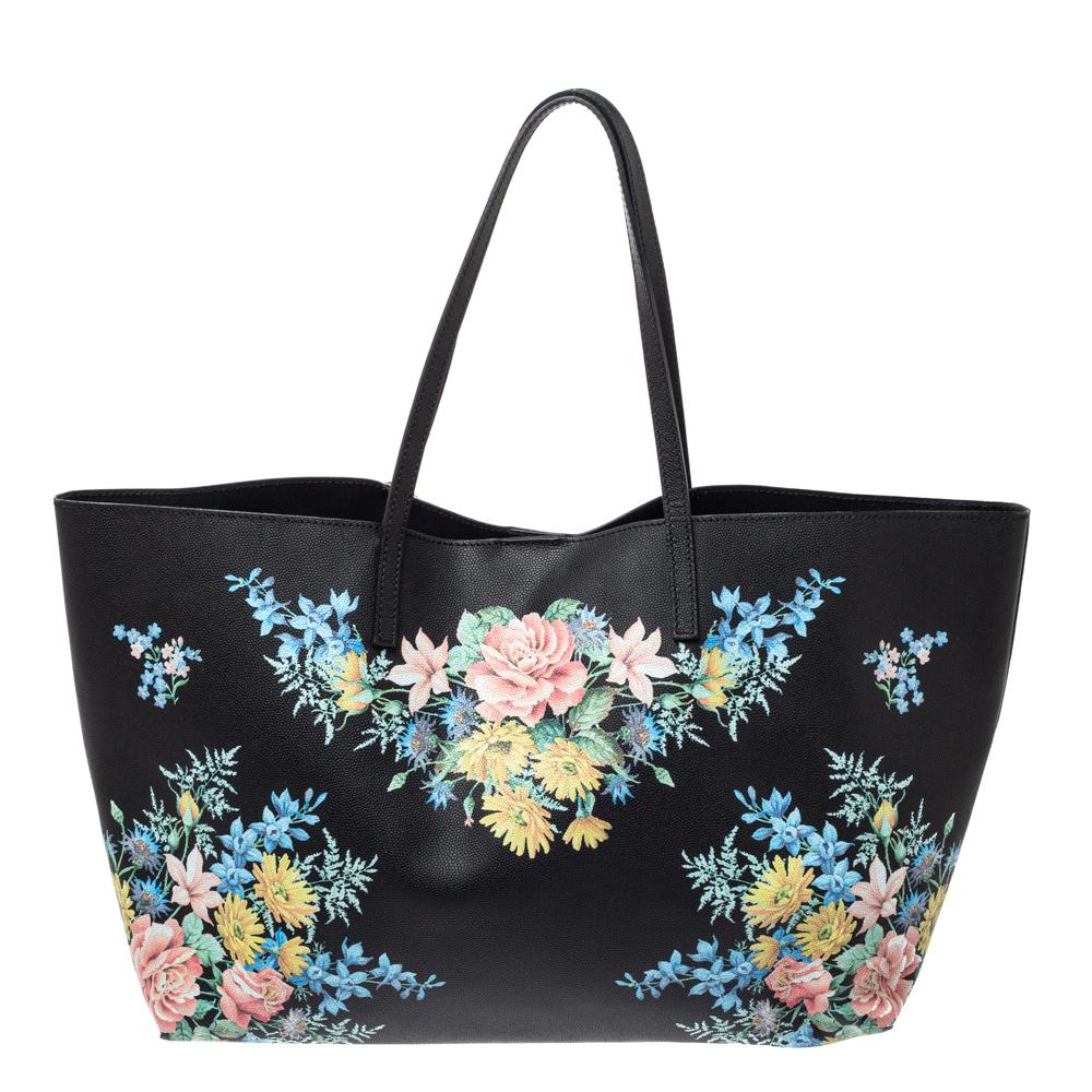 We all need one tote that will not only help assist our style but also be durable enough for our shopping sprees. Here's one from Alexander McQueen. It comes finely crafted from floral-printed leather and designed with two handles and a spacious