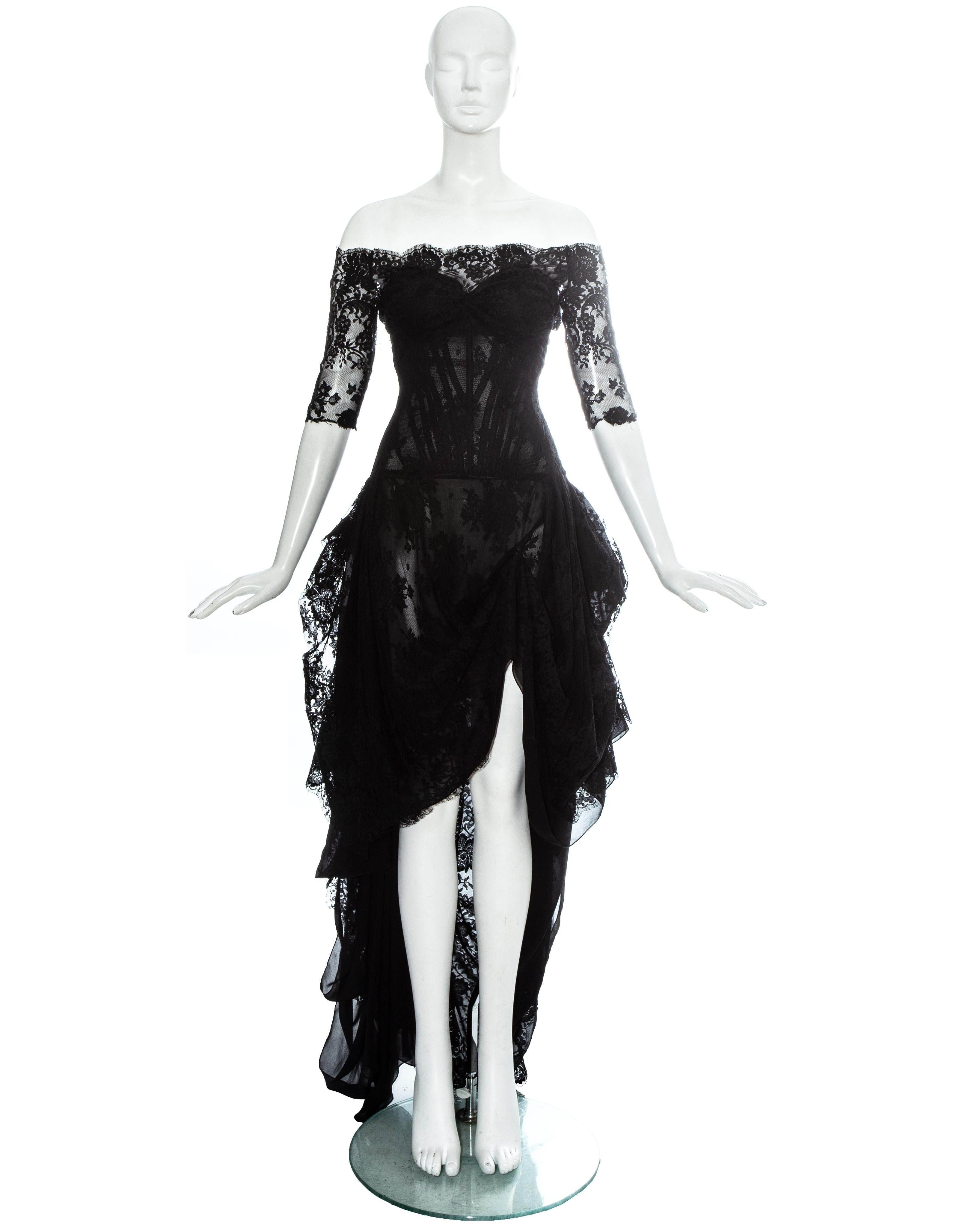 Alexander McQueen black lace evening dress with internal corset, dropped shoulders, low back with bustled rear, the skirt cut short at the front with an optional hook-and eye fastening to create a leg slit, and long trained hem

'Sarabande',