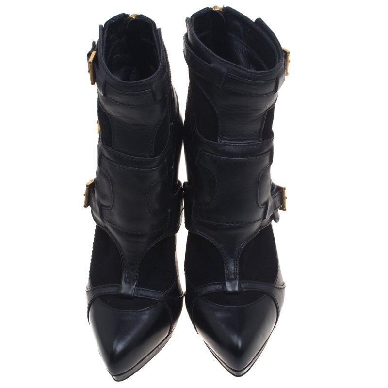 This stunning pair of boots from Alexander Mcqueen are crafted from leather and suede. The ankle length black boots have an angular heel and buckle detailing. The round toe boots have a rear zip fastening. The boots are sure to make heads turn.