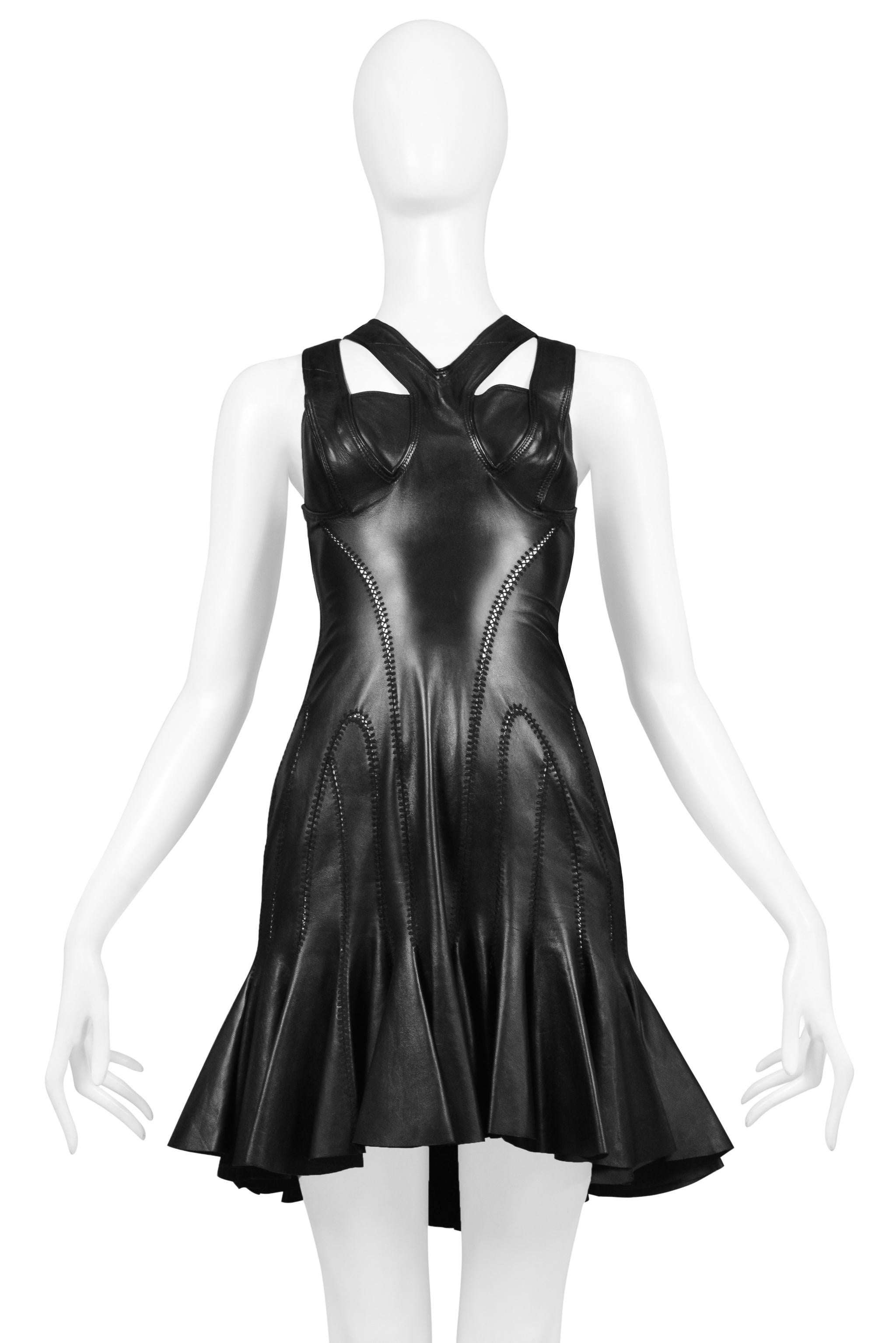 Resurrection Vintage is excited to offer an Alexander McQueen black leather bondage dress featuring multiple straps, bra detail, exposed back, decorative seaming, flounce panels, and mini length.

Alexander McQueen
Size: No label. Today's Size S or