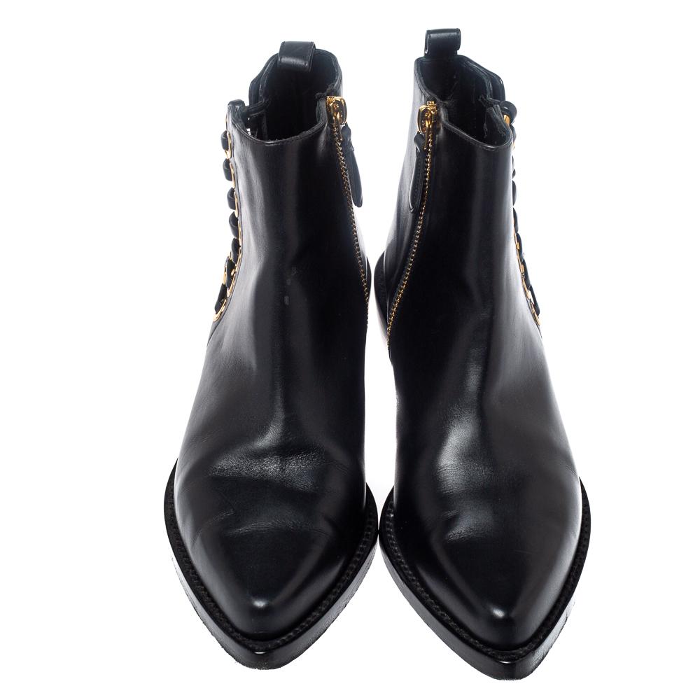 These Chelsea boots from Alexander McQueen brings a grand fusion of funk and modern style. They are crafted from quality leather and detailed with pointed toes, gold-tone hardware, zip closure, and braided chain detailing. You will surely be able to