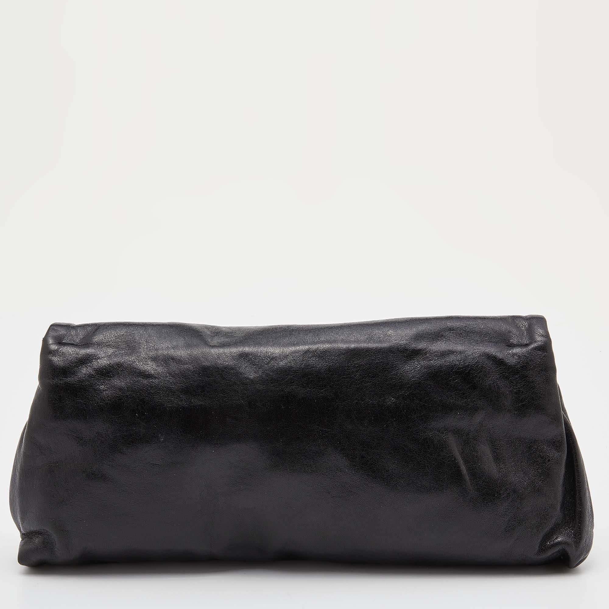Always pushing the boundaries of creativity and burring the lines between fashion and edge, Alexander McQueen is a brand we cannot help but love. This clutch from the brand is a fun take on a staple accessory. It is crafted from leather and it is
