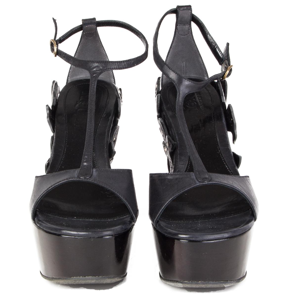 100% authentic Alexander McQueen platform wedge sandals embellished with laser-cut flowers and leaves in black calfskin. Have been worn and are in excellent condition. 

Measurements
Imprinted Size	36
Shoe Size	36
Inside Sole	23.5cm