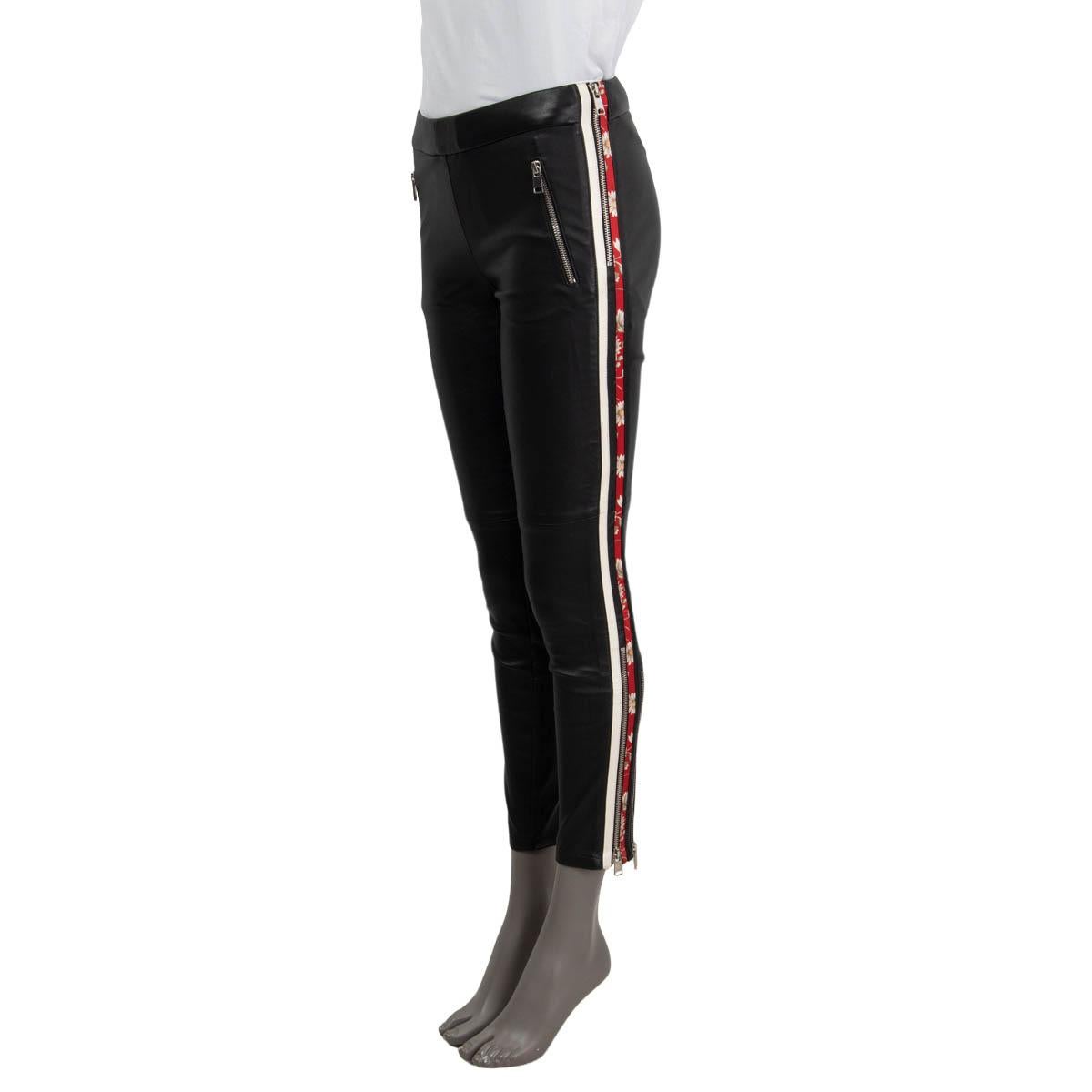 100% authentic Alexander McQueen floral-striped stretchy skinny pants in black lambskin (100%) with black lining in cotton (97%) and elastane (3%). Silver-tone zipper details on the calf and two front zip pockets. Red, white and green floral printed