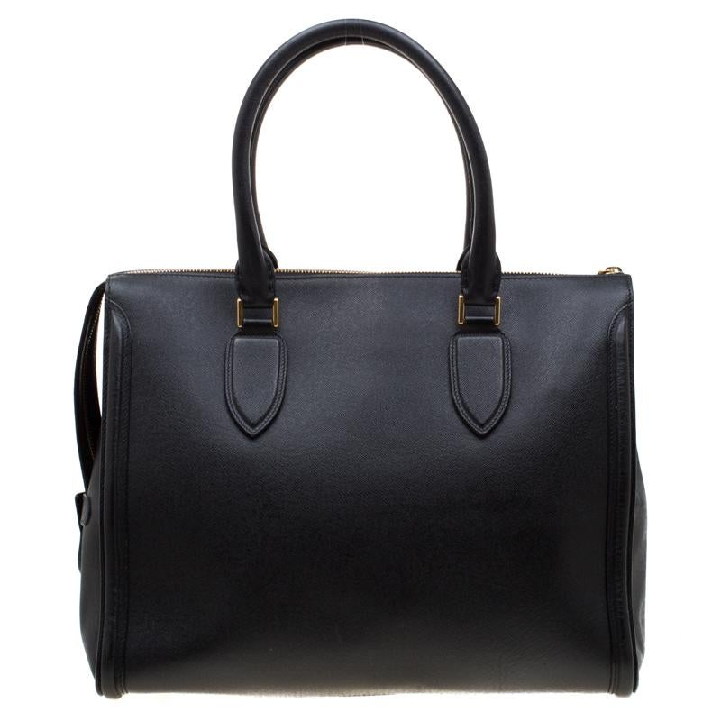 Every woman needs a bag that is pretty and functional, just like this tote from Alexander McQueen. Crafted from leather, it has a spacious canvas interior, two top handles and metal feet. This is definitely one handy bag that deserves to be