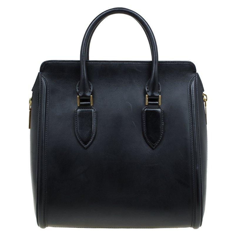 A sturdy fine leather body and double carry handles, the bag comes with a structured design and a flap closure for the main pocket. With gold-toned hardware to complement the sophisticated styling, it features a large pocket and a rigid base with