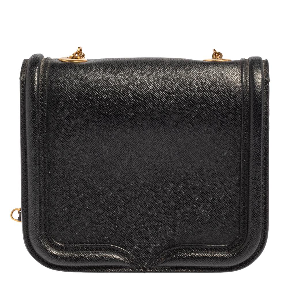 Every woman needs a bag that is pretty and functional, just like this shoulder bag from Alexander McQueen. Crafted from leather, it has been styled with a flap leading to a spacious suede interior and it is held by a shoulder strap. This is