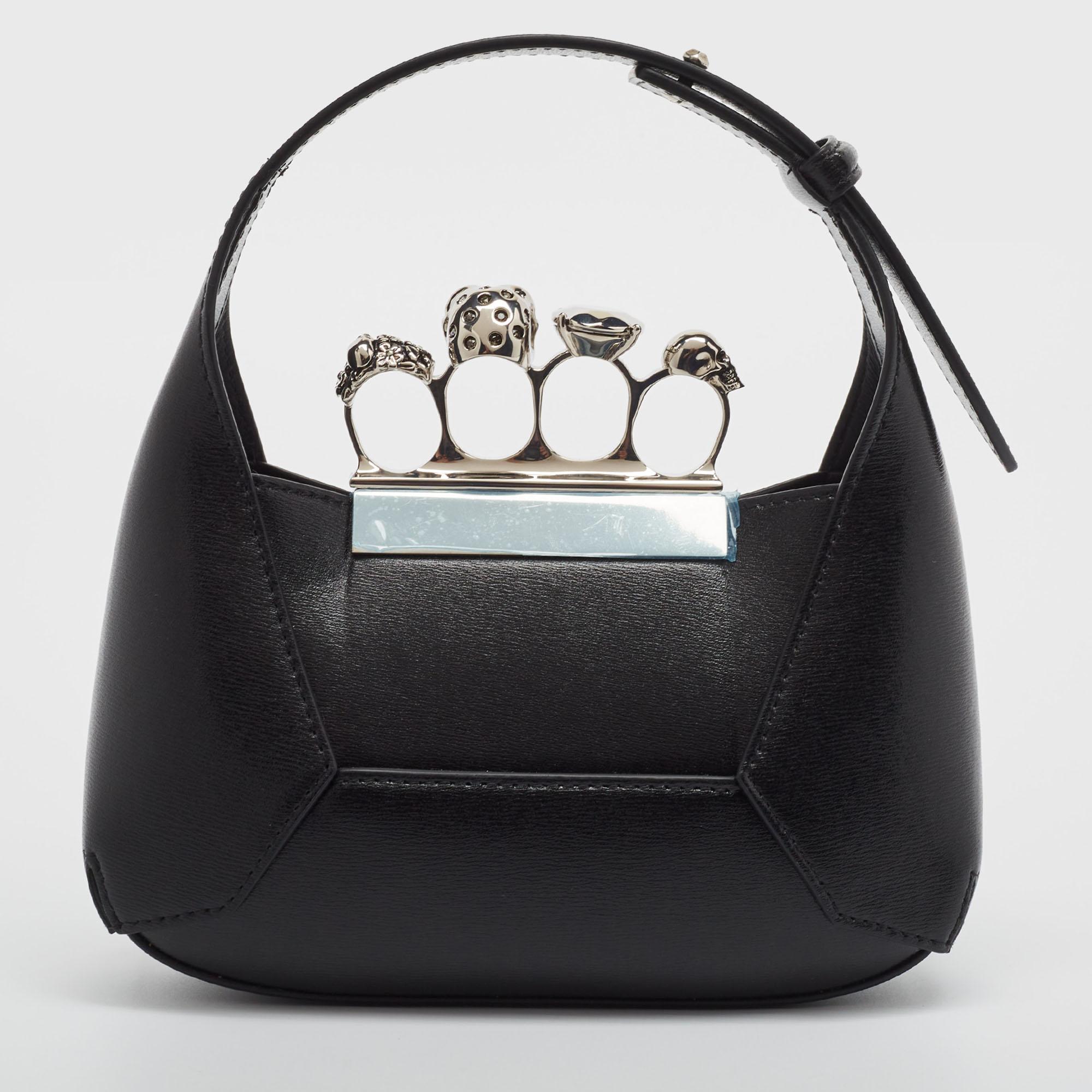 Crafted with the finest black leather, the Alexander McQueen Jeweled hobo exudes opulence. Its compact design is adorned with dazzling jewels, adding a touch of glamour to any ensemble. Practical yet luxurious, this hobo seamlessly blends style with