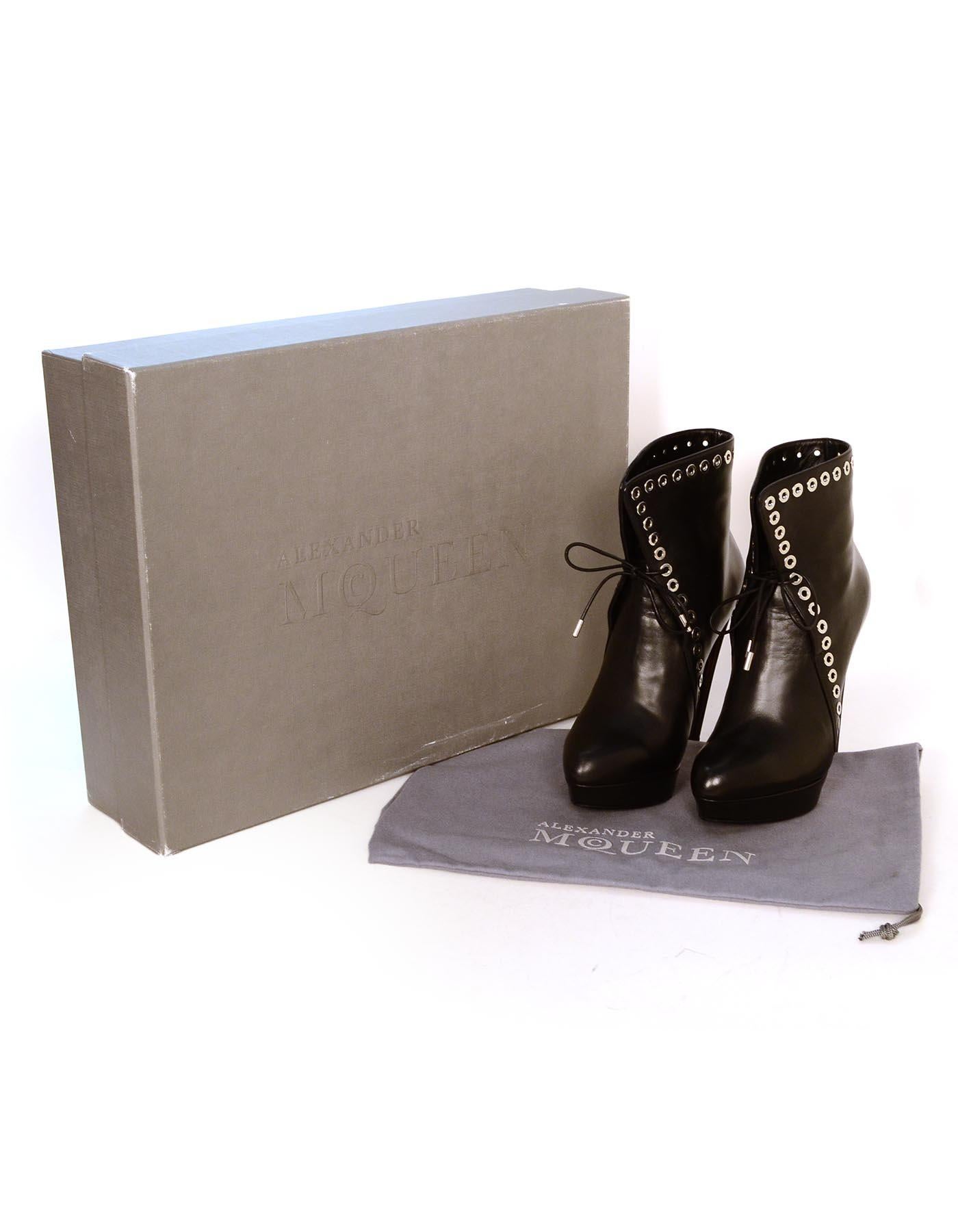 Alexander McQueen Black Leather Silvertone Grommet Heeled Platform Boots Sz 37

Made In: Italy
Color: Black, silver
Hardware: Silvertone
Materials: Leather, metal
Closure/Opening:  Lace up front
Overall Condition: Excellent pre-owned condition with