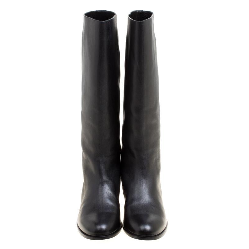 Stay on style with this pair of boots from Alexander McQueen! Beautifully crafted from leather, these mid-calf boots carry round toes and trim of spikes on the back. Waltz around town in this lovely pair!

Includes: Original Box

