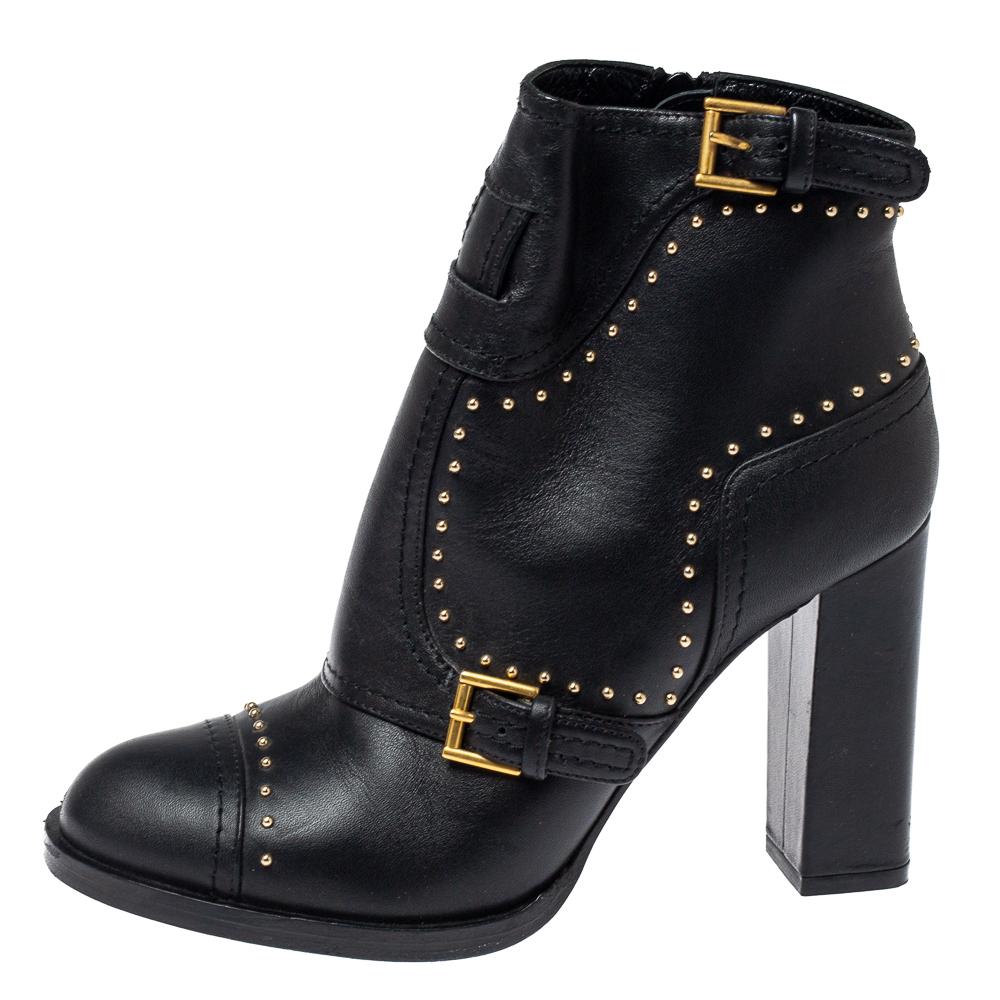 Enjoy the most fashionable days with these stylish ankle boots from Alexander McQueen. Modern in design and craftsmanship, they are crafted from leather and designed with gold-tone studs, buckles, and side zip closure. They are finished with 9 cm