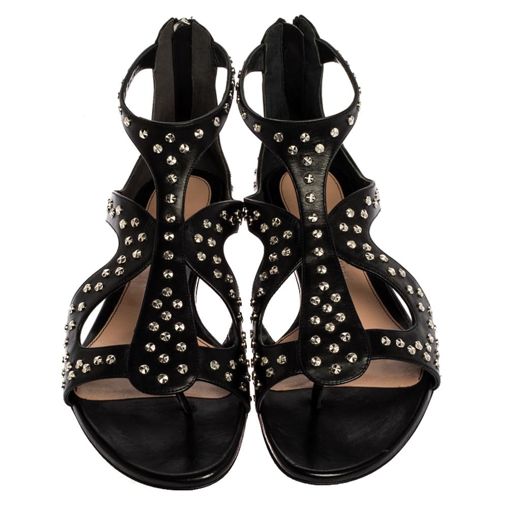 Alexander McQueen's flat sandals are designed to elegantly frame the feet. Crafted from black leather, the sandals feature a cage-like design, stud embellishments all over, and sturdy outsoles. The timeless shade of black makes it a notice-worthy