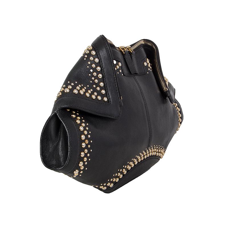 Alexander McQueen 'De Manta Studded' clutch in black leather with gold-to-silver-tone studs. Closes with a two-way zipper on top. Lined in black cotton with an open pocket against the back. Has been carried and is in excellent condition. 

Height