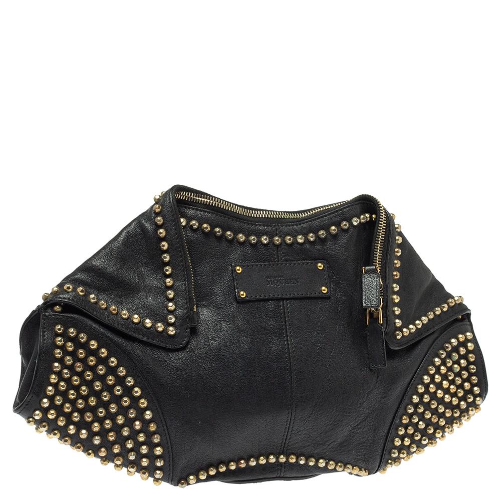 Alexander McQueen brings you this super-edgy clutch that carries a unique silhouette. It has a black shade, folded top edges, and double zippers that lead to a fabric interior. Gold-tone studs heighten the whole look.

Includes: Original Dustbag