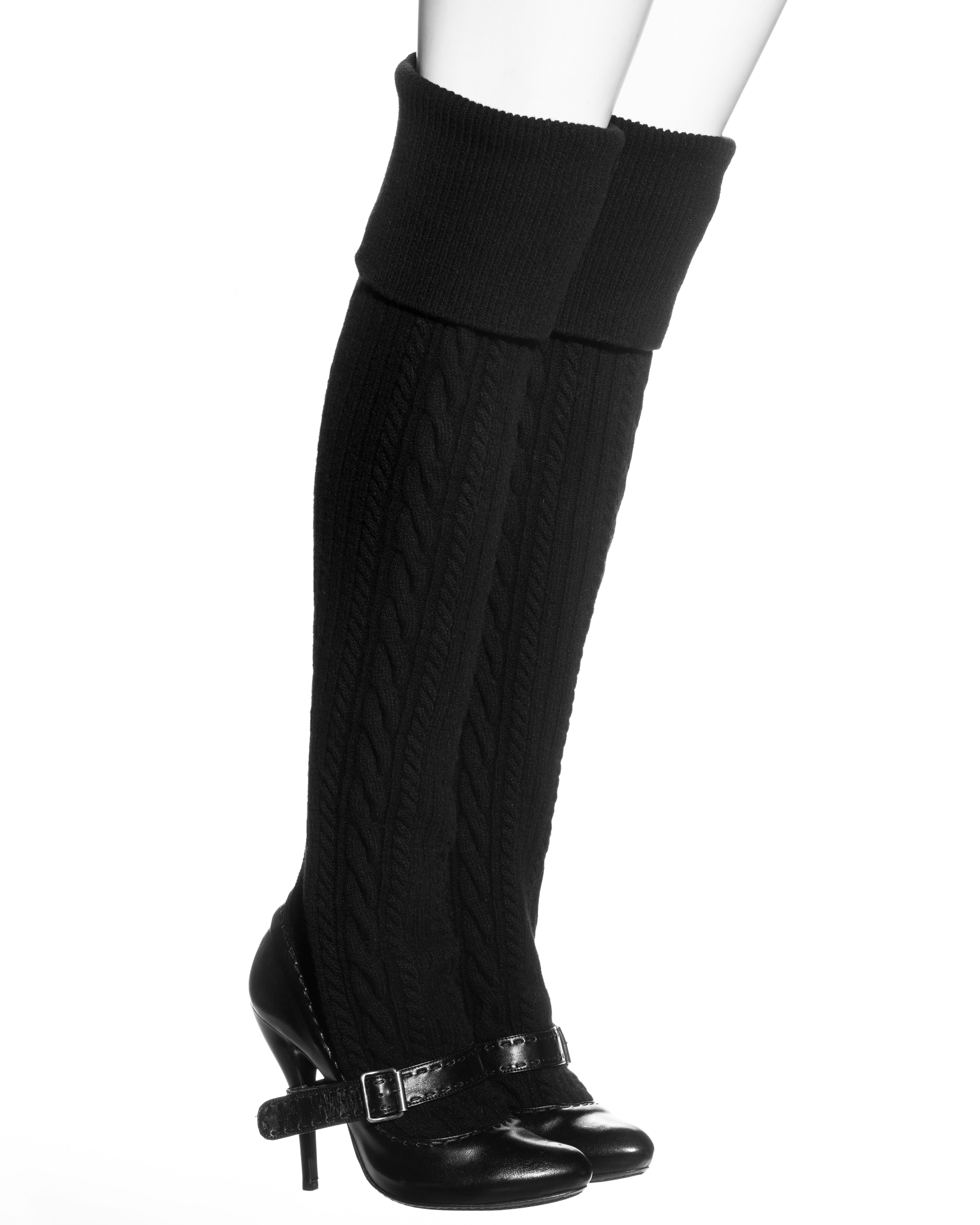▪ Alexander McQueen black thigh-high boots
▪ Black leather high-heel pumps 
▪ Attached knitted thigh-high socks 
▪ Black buckle strap around the heel and foot
▪ Size European 40 
▪ Fall-Winter 2006
▪ Made in Italy