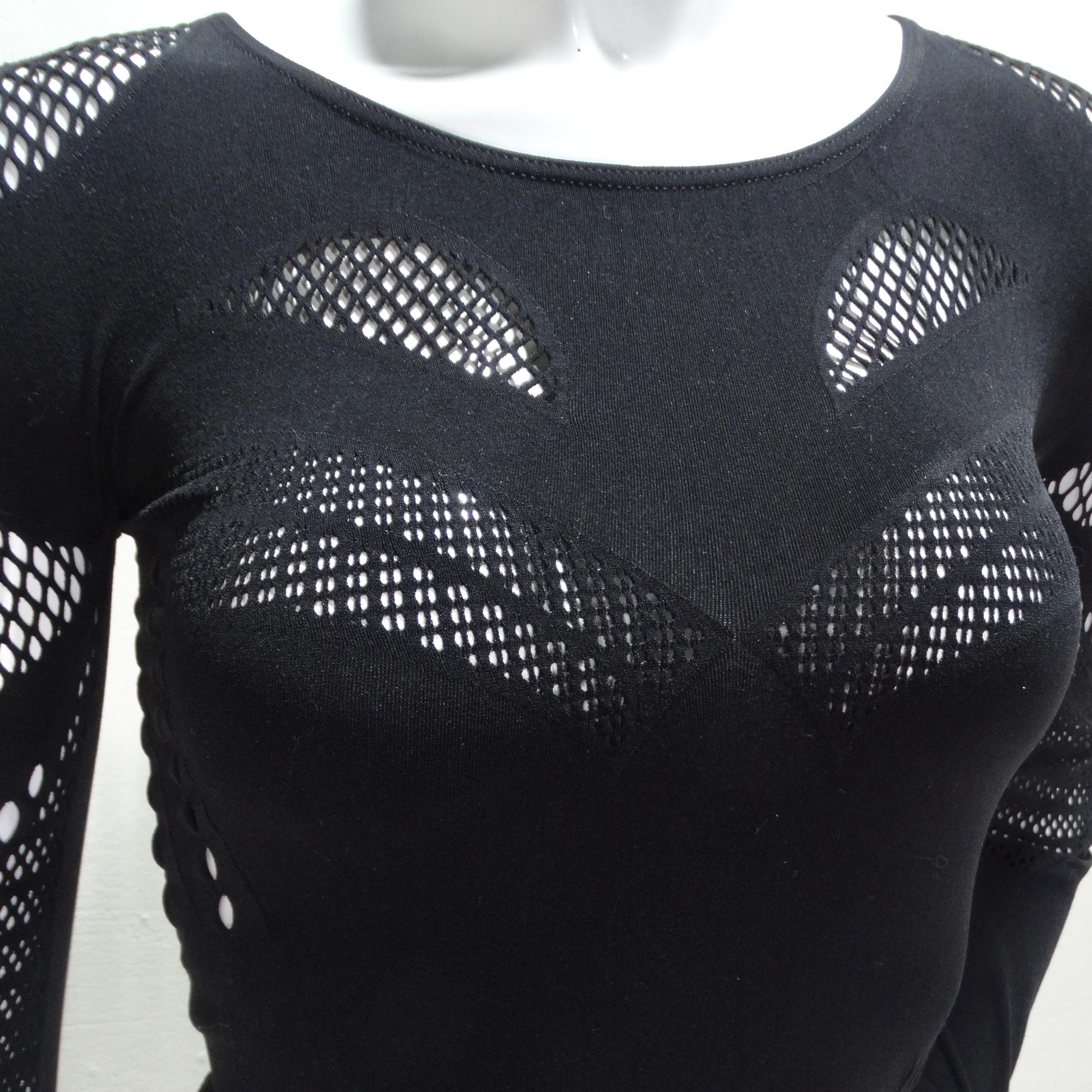 Introducing the Alexander McQueen Black Mesh Cut Out Top – a daring and sophisticated addition to your wardrobe that seamlessly combines elegance with edginess. This black long sleeve ultra-stretchy knit top is designed to captivate attention with