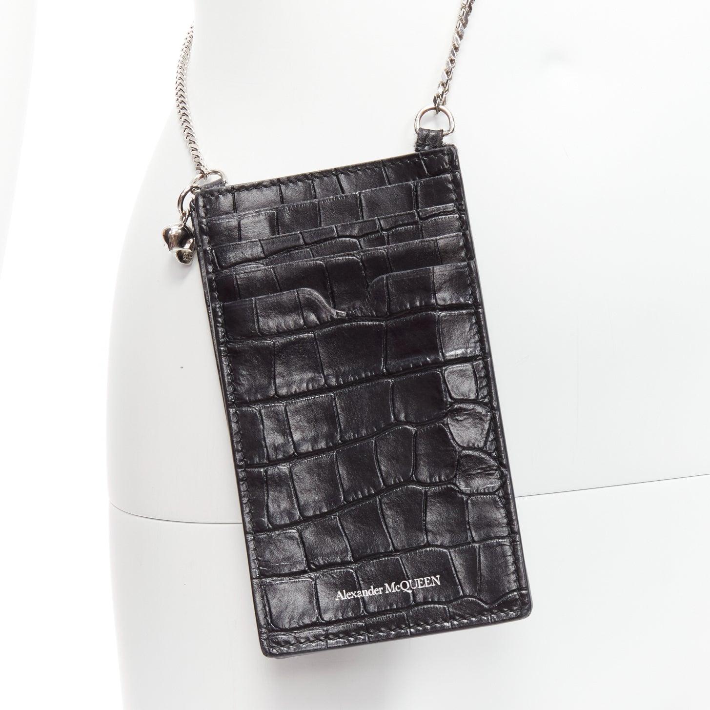 ALEXANDER MCQUEEN black mock croc leather skull charm silver chain logo crossbody phone holder bag
Reference: KEDG/A00259
Brand: Alexander McQueen
Material: Leather, Metal
Color: Black
Pattern: Animal Print
Lining: Black Leather
Extra Details: Skull