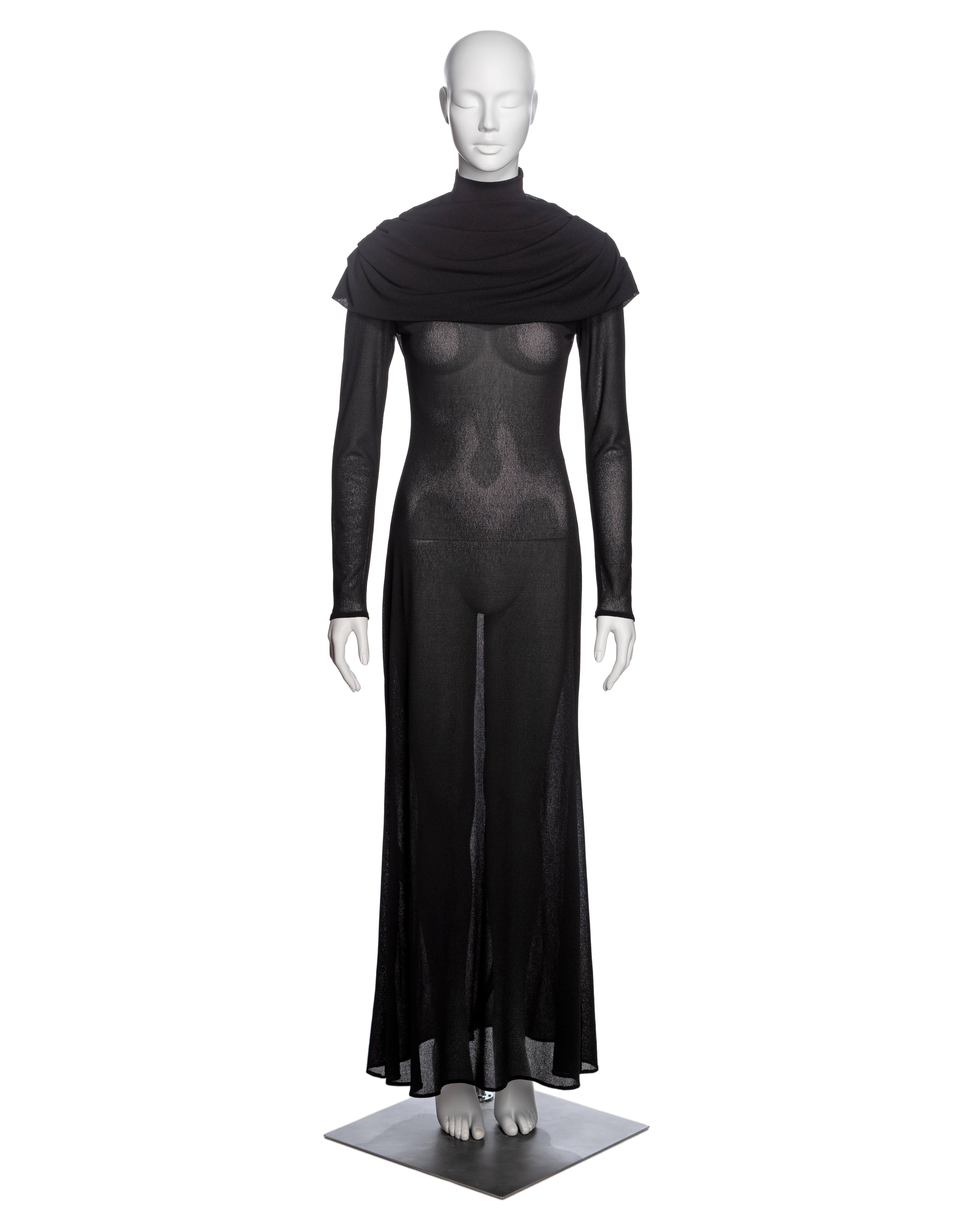 ▪ Brand: Alexander McQueen
▪ Creative Director: Lee Alexander McQueen
▪ Collection: Fall-Winter 1998
▪ Fabric: Black polyester crepe
▪ Details: Mock neck with a built-in draped cowl, long fitted sleeves with mother-of-pearl buttons, A-line maxi