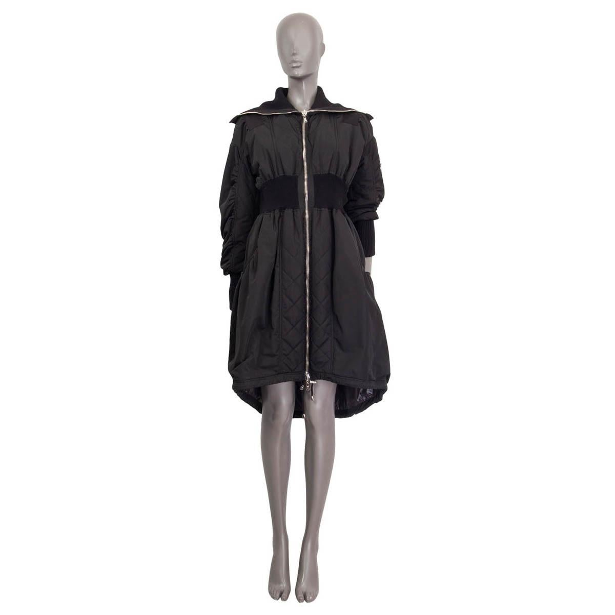 100% authentic Alexander McQueen flared coat in black polyester (100%). Features a ripped waist, a ripped high neck and ripped cuffs. Has two slit pockets on the front and a zip pocket on the sleeve. Opens with a zipper on the front. Lined in black