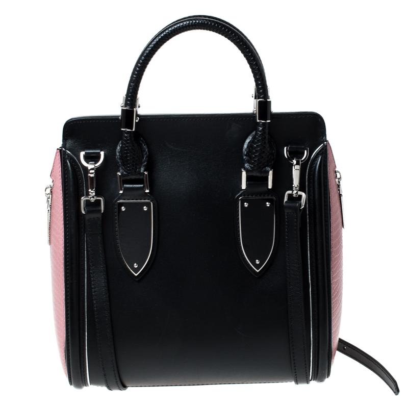 Every woman needs a bag that is pretty and functional, just like this shoulder bag from Alexander McQueen. Crafted from leather, it has been styled with a flap leading to a spacious suede interior and it is held by two top handles. This is