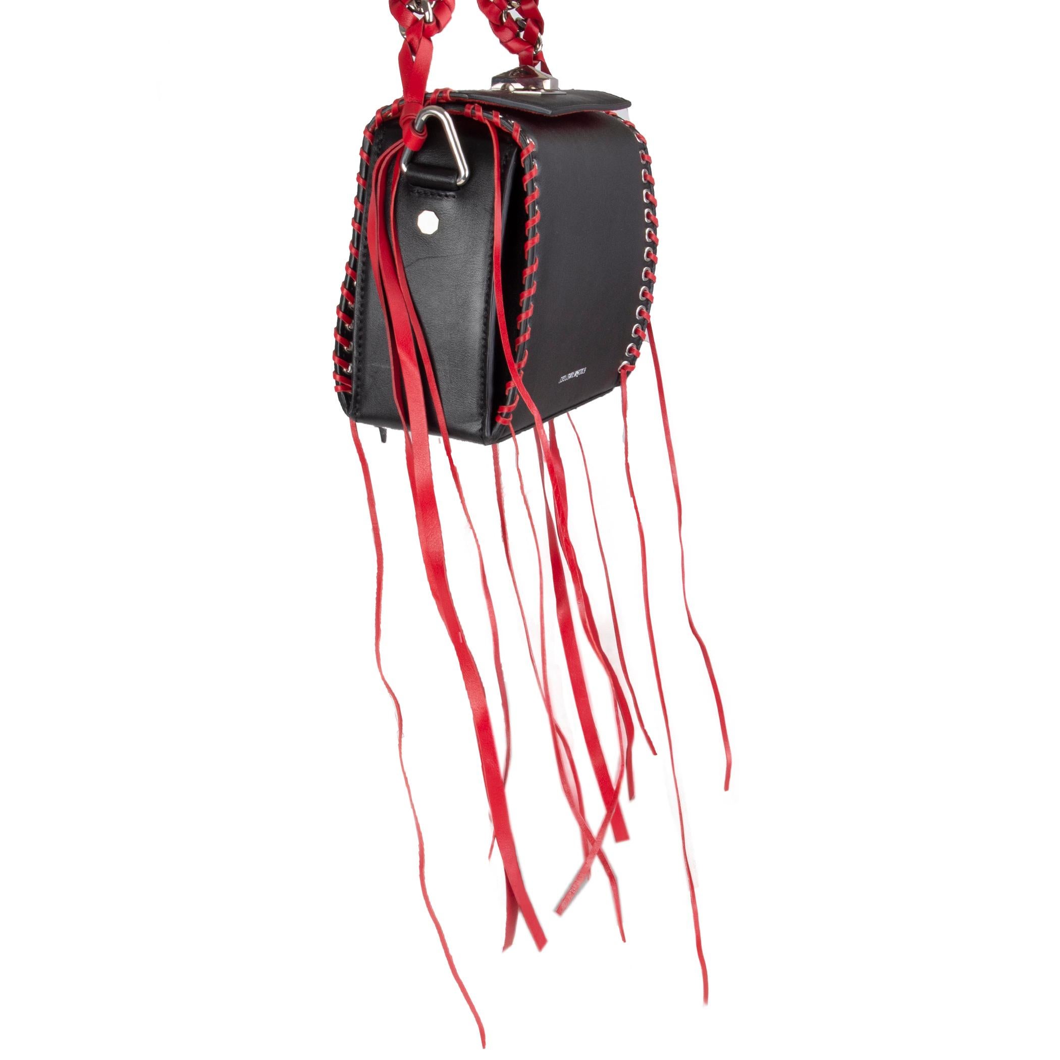 Alexander McQueen 'Box 19' shoulder bag in black leather with silver-tone eyelits and read leather whipstitch details and red leather and chain handle. Detachable shoulder strap. Opens with a turn-lock on top. Inside is divided into three