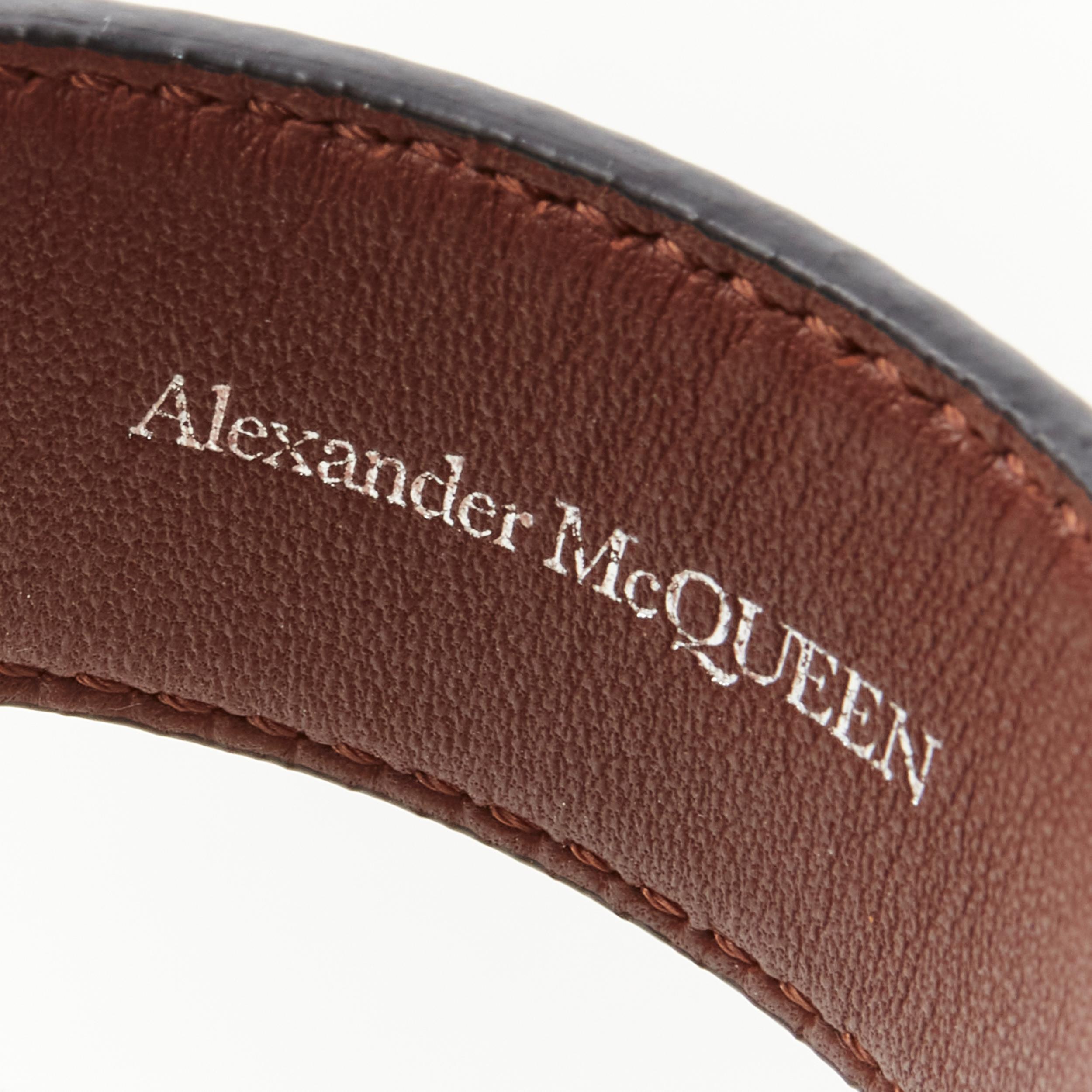 Black ALEXANDER MCQUEEN black rhinestone metal tip gold buckle leather cuff bracelet
