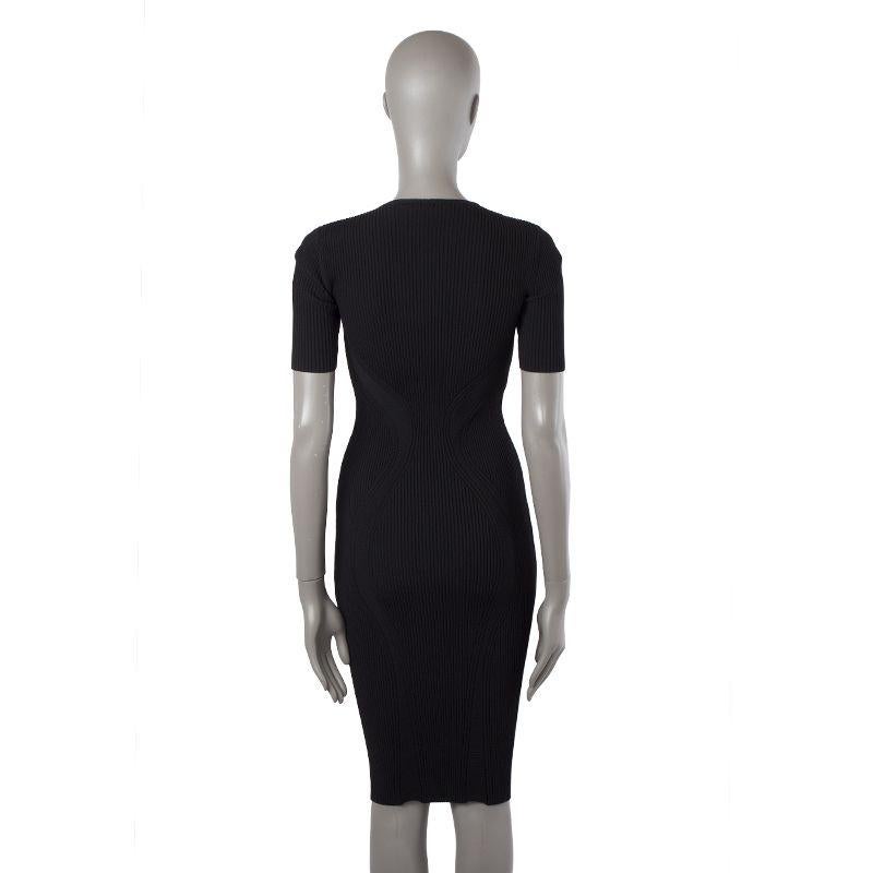 Alexander McQueen ribbed knit short-sleeve bodycon in black fabric (missing tag) with crew neck and peekaboo details on the chest. Unlined. Has been worn and is in excellent condition.

Tag Size Missing Tag
Size XS
Shoulder Width 30cm (11.7in)
Bust