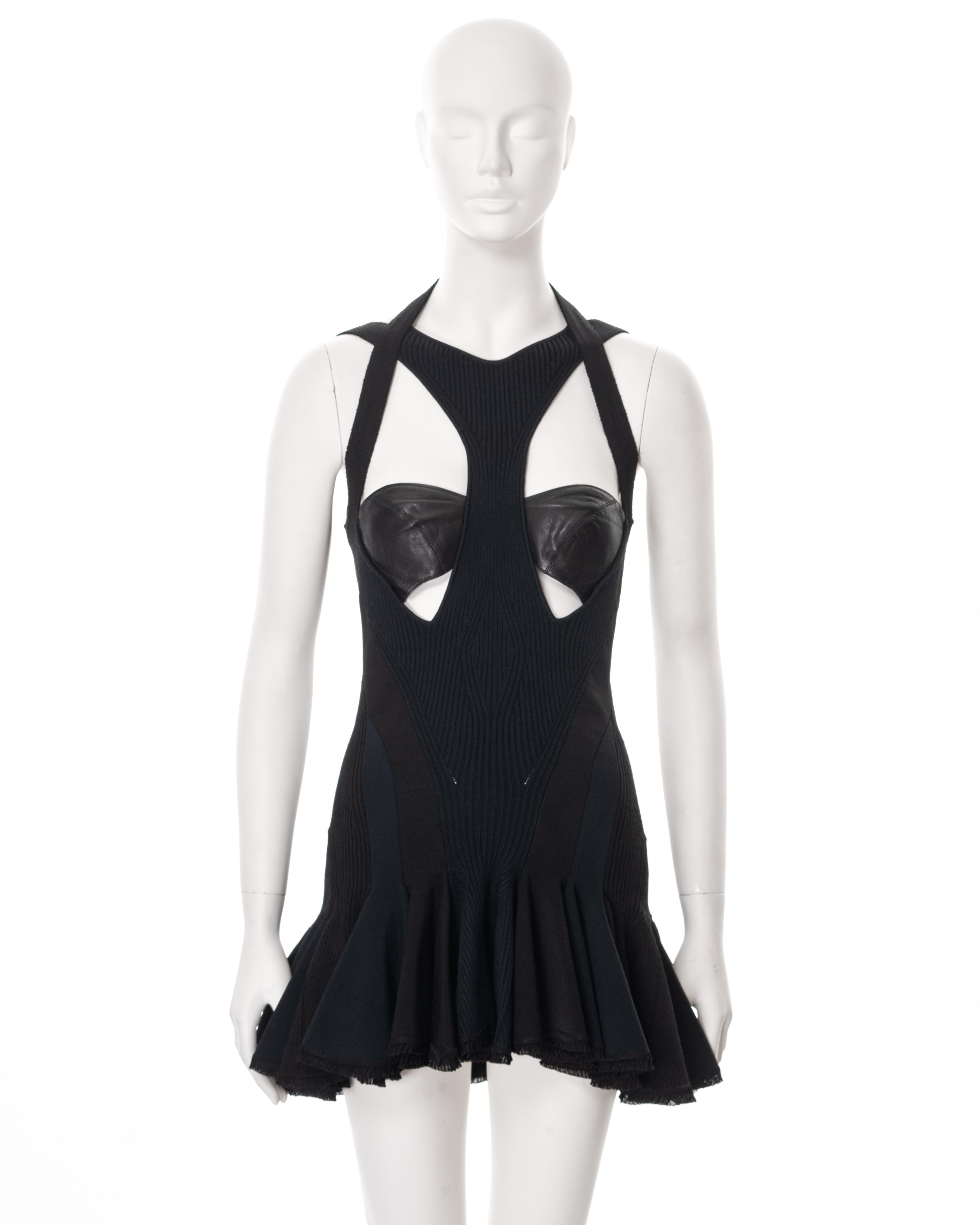 ▪ Alexander McQueen mini dress 
▪ Sold by One of a Kind Archive
▪ Spring-Summer 2004 
▪ Constructed from black rib knit, spandex jersey and leather 
▪ Built-in leather bustier 
▪ Multiple criss-cross shoulder straps 
▪ Gored graduated mini skirt
▪