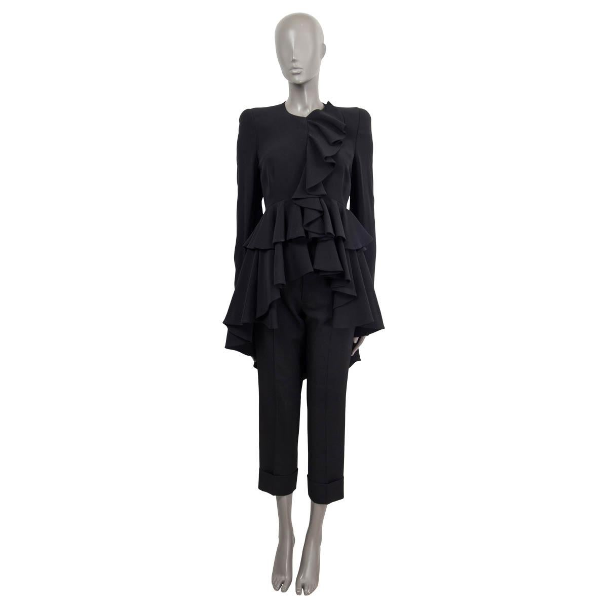 100% authentic Alexander McQueen long asymmetrical tuxedo blazer in black acetate (50%) and viscose (50%). Features ruffled details, zipped cuffs and padded shoulders. Opens with concealed hooks and push buttons on the front. Lined in acetate (76%)