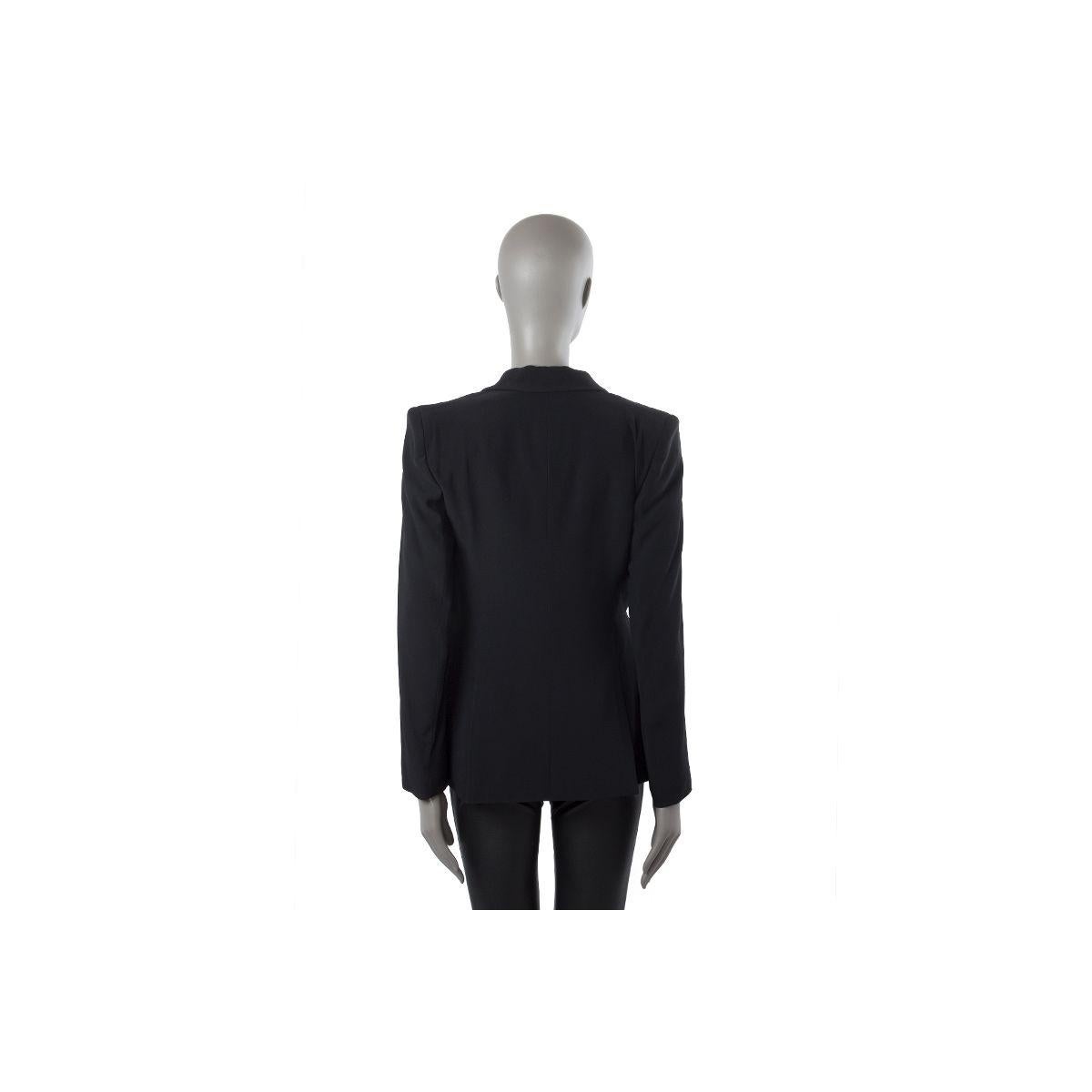100% authentic Alexander McQueen tuxedo jacket in black acetate (50%) and viscose (50%). With satin peak collar, one chest pocket, two front flap pockets, and two back slits. Closes with one black and golden rhinestone flower button on the front.