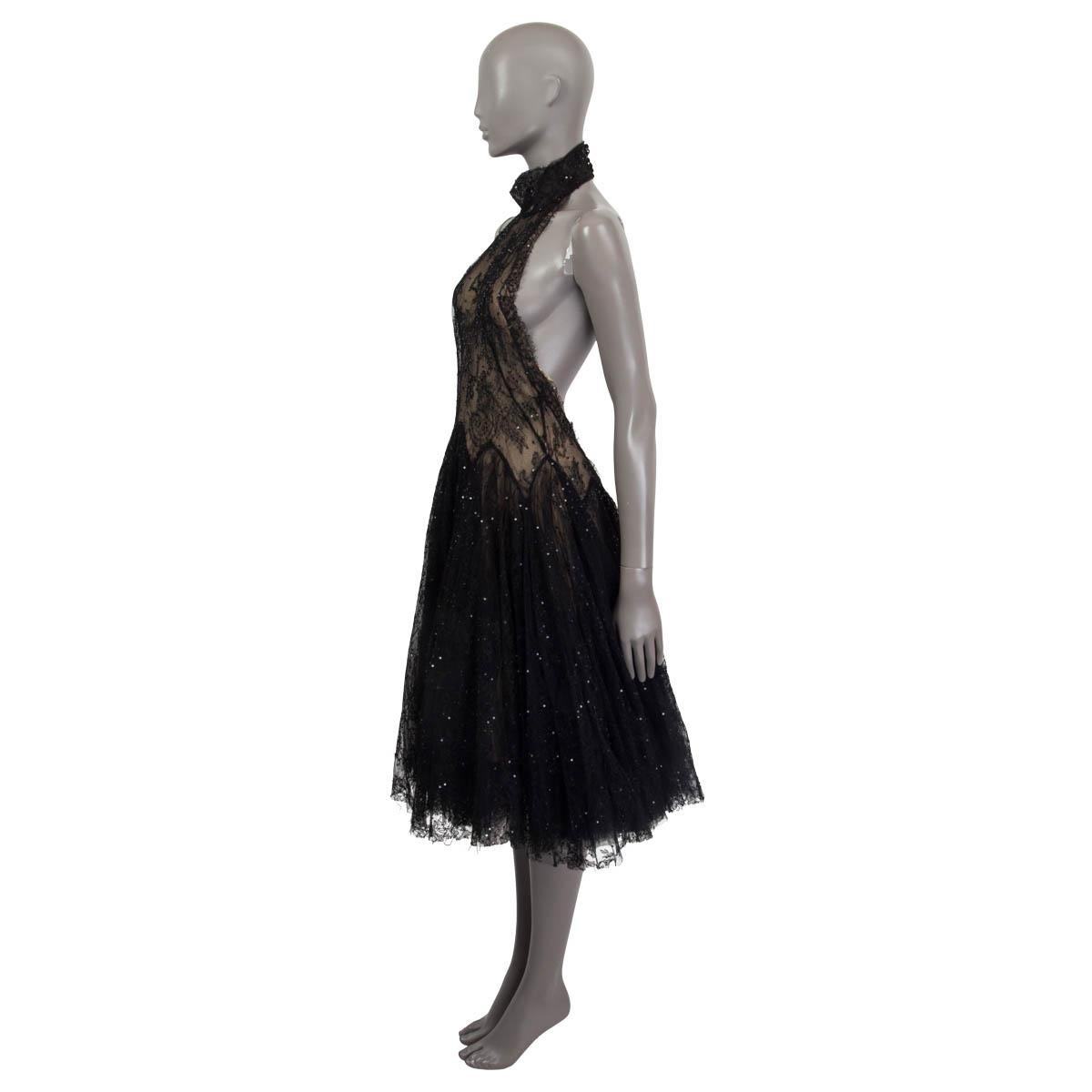100% authentic Alexander McQueen knee length sequins embellished cocktail dress in black and beige viscose (70%) and polyamide (30%). Features a halter neck that opens with six buttons on the back (one button shows a faint stain), two tulle layers