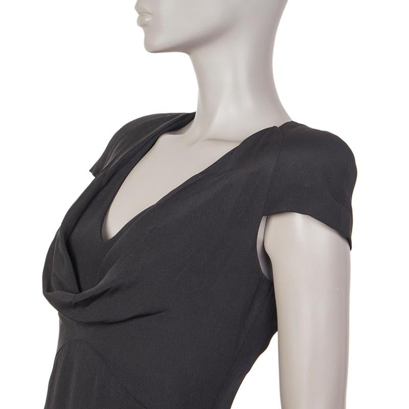 Alexander McQueen cap-sleeve sheath dress in black silk (100%). With padded shoulders, cowl neck, and slit on the back of the skirt. Closes with invisible zipper on the back. Lined in black silk (100%). Has been worn and is in excellent condition.