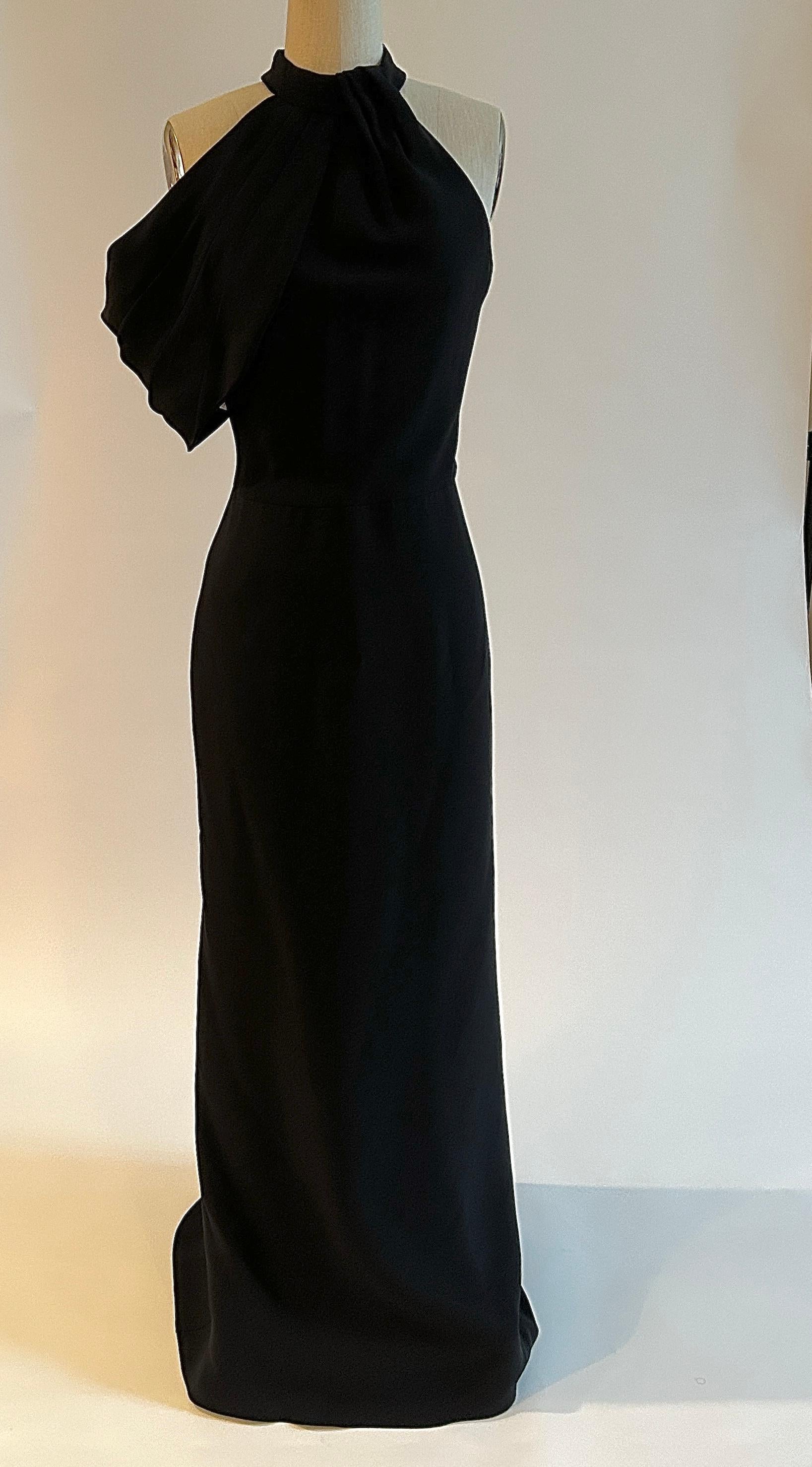 Alexander McQueen 2017 black silk gown with a pleating at color and asymmetrical draped arm detail. Back zip with two snaps and buttons at back neck. 

100% silk.
Fully lined in 100% silk. 

Made in Italy.

Size 40 IT, approximate US 4. See