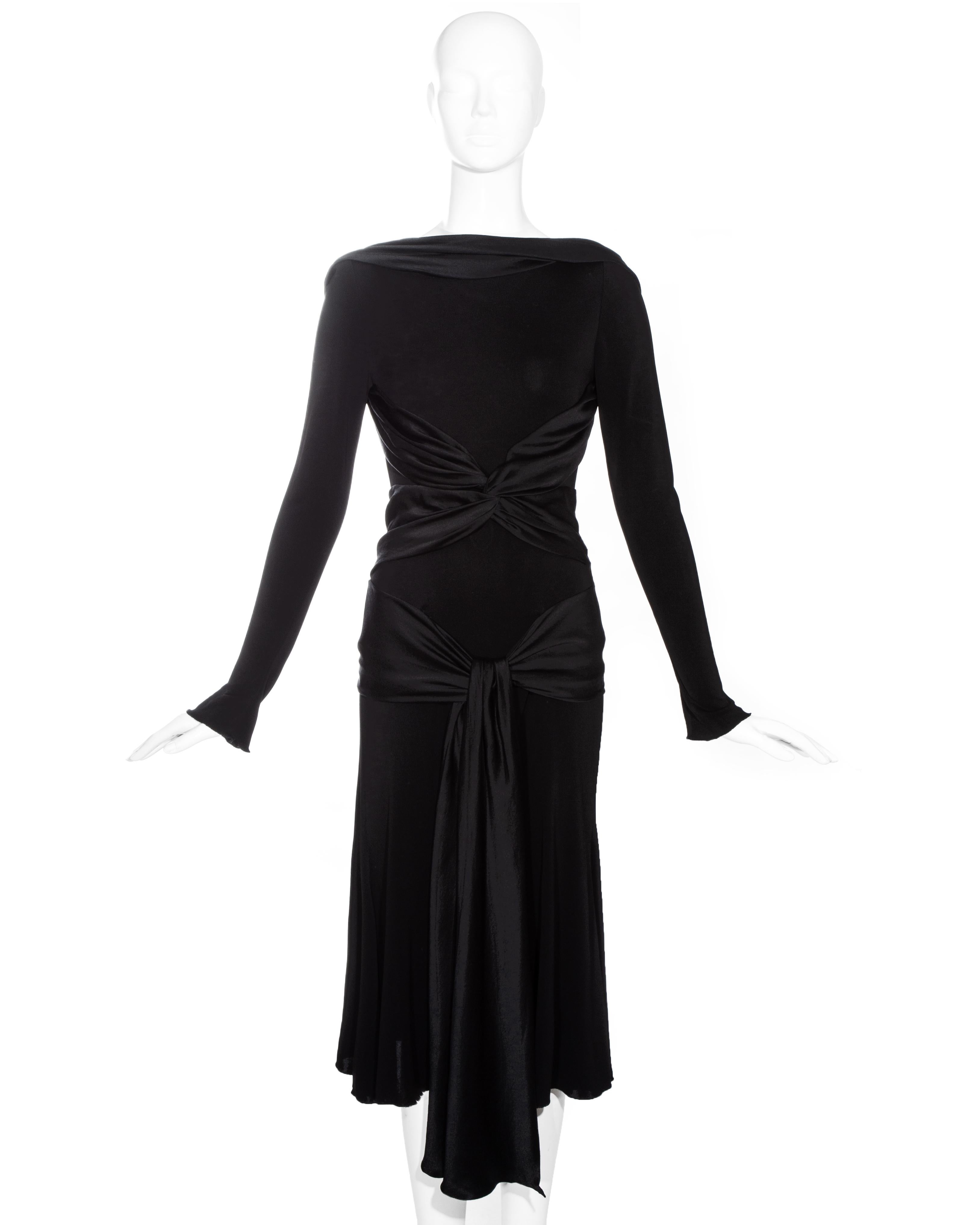 Alexander McQueen black evening dress with appliquéd silk scarfs fastening around the hips.

Fall-Winter 2004