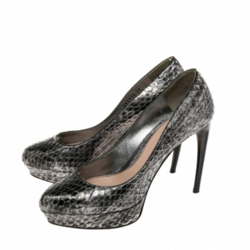 Featuring a chic, minimalist design, these pumps from Alexander McQueen are easy to style. Python exteriors showcase black and silver hues. High heels and almond toes form a distinctive outline. Their simple design pairs equally well with casual