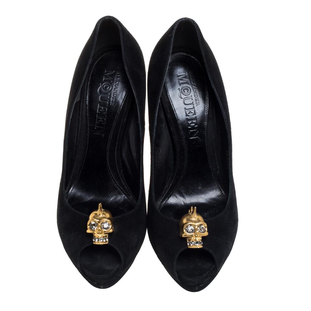 If you're someone who has a love for things that are edgy and unique, then Alexander McQueen's designs are perfect for you. These McQueen pumps are anything but dull. they feature crystal-embellished gold-tone skull motifs over the peep toes, solid
