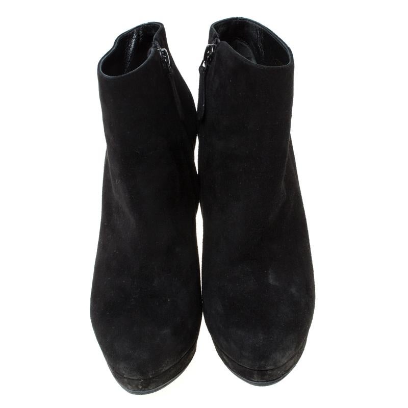 These Alexander McQueen ankle boots are sure to be your favourite for the season. Designed from a classic black suede body, this pair is set on a platform sole and features slender heels. It is secured with a side zip closure that ensures a snug