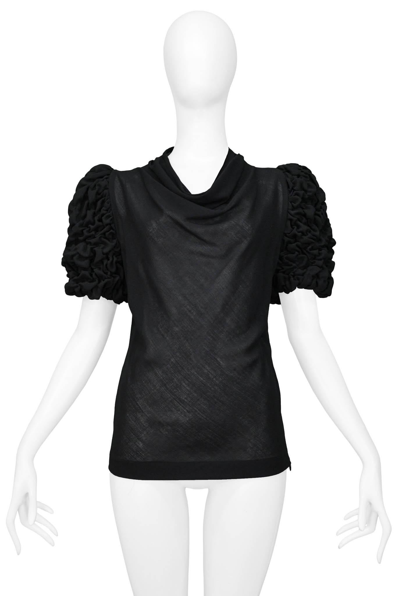 Resurrection Vintage is excited to offer an important Alexander McQueen black top featuring puckered sleeves, a draped pleated neckline, and an invisible zipper on the side seam.
Alexander McQueen
Size 40
Wool
AW 1999 The Overlock