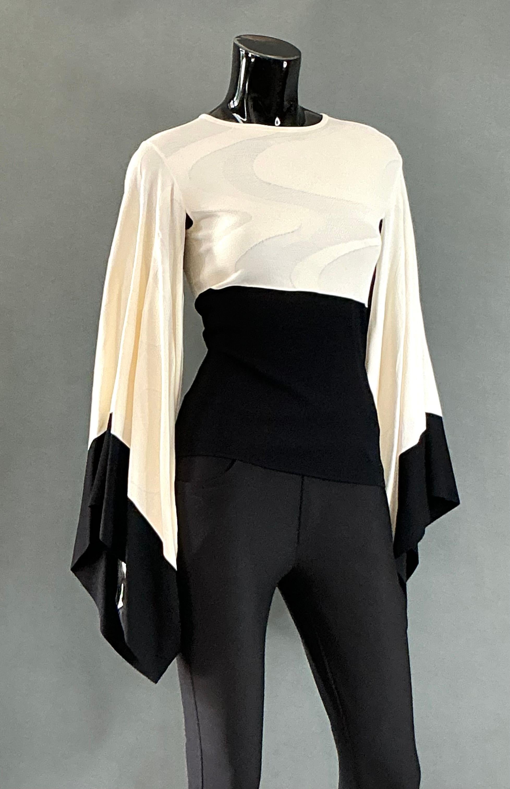 The Vintage Alexander McQueen Bat Wing Knit Top would be an exciting addition to any wardrobe, especially for someone who enjoys pieces that combine boldness, sophistication, and artistic design. The dramatic butterfly sleeves would add a sense of