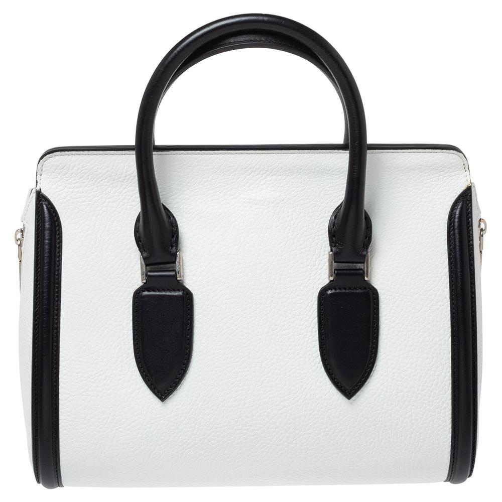 Every woman needs a bag that is pretty and functional, just like this Heroine satchel from Alexander McQueen. Crafted from leather, it has been styled with dual zip closures on the sides and a flap that opens to a spacious suede interior. It is held