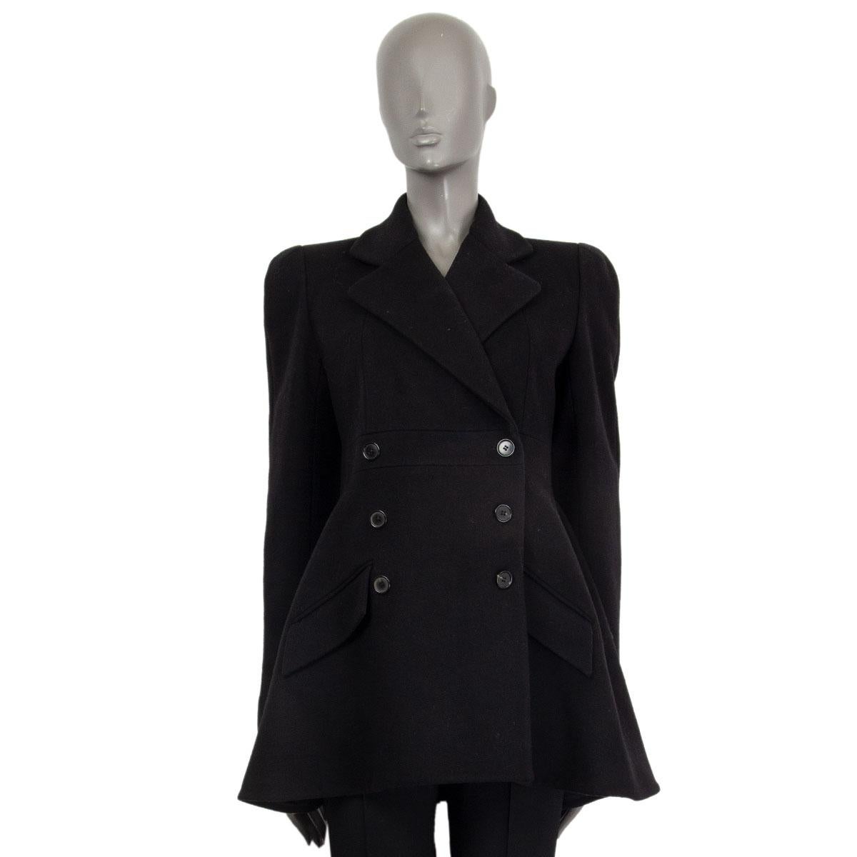 Alexander McQueen double breasted short coat in black wool (95%) and cashmere (5%) with a notch collar and two front decorative pockets. Closes on the front with buttons. Lined in curpo (100%). Flares at the bottom. Has been worn and is in excellent