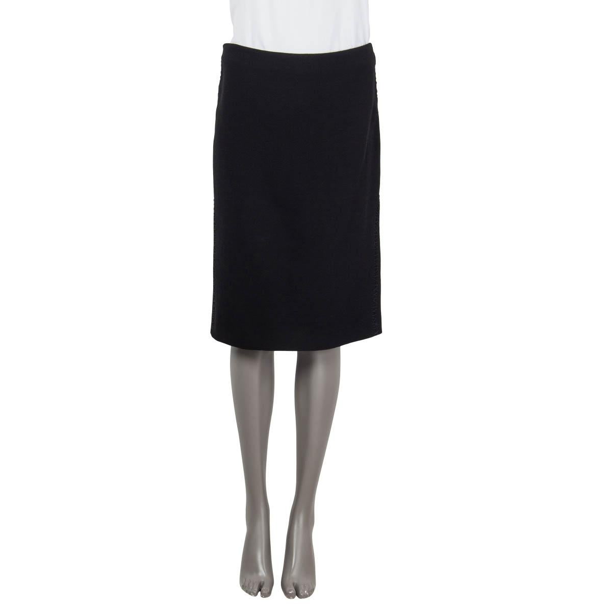 100% authentic Alexander McQueen knee-length straight skirt in black wool (100%) embellished with tonal stitching details on the side and on the back. Opens with a zipper on the back and is lined. Has been worn and lining shows a ripped part by the