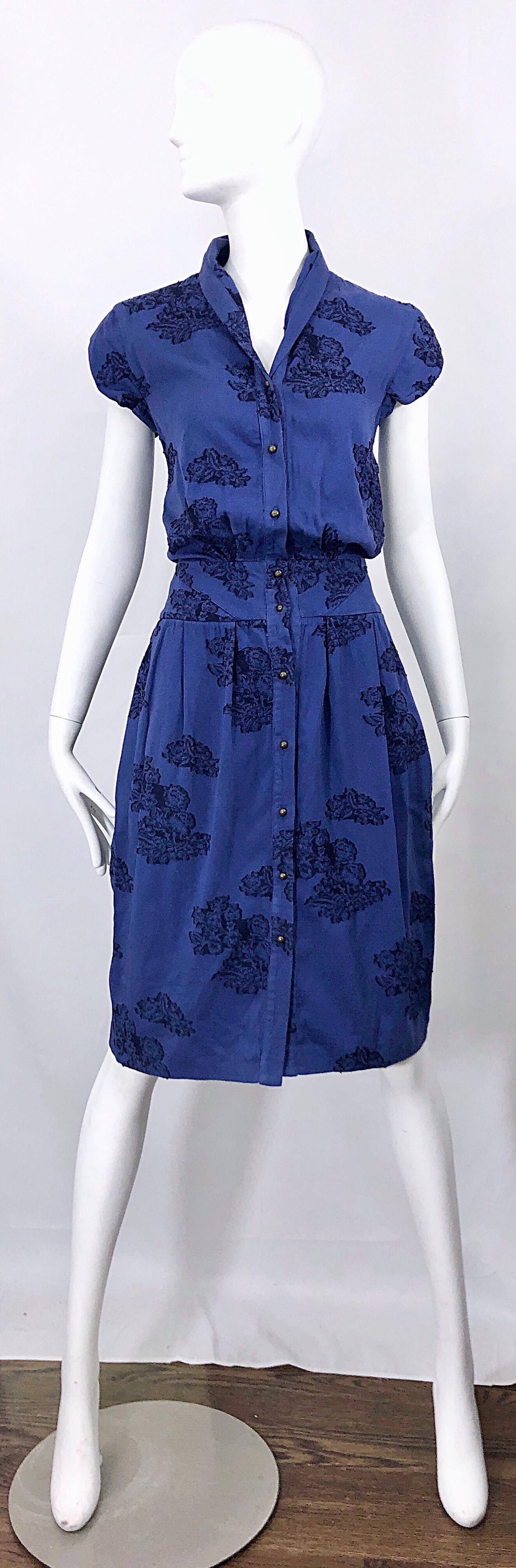 Chic ALEXANDER MCQUEEN royal blue and black lace print 50s style cotton bustle dress! Fitted bodice, with cap sleeves and a flattering skirt. POCKETS at each side of the hips. Nickel colored metal ball buttons up the front. Can easily be dressed up