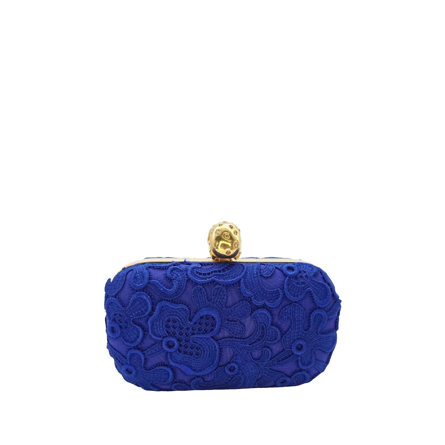 Exude elegance and sophistication with the Alexander McQueen Blue Lace Pochette Clutch. Crafted for bold fashionistas, this classic beauty features blue lace and a crystal-adorned skull toggle clasp. The spacious leather-lined interior holds just