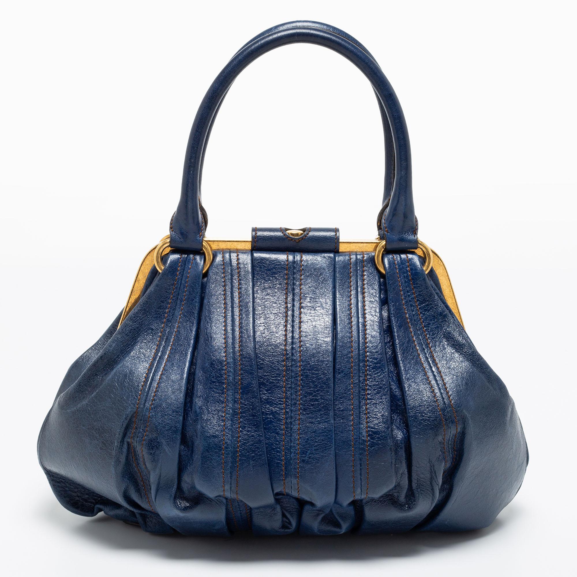 Easy to carry and stylish in appearance, this Elvie satchel from Alexander McQueen will certainly be your favorite pick this season. It is crafted using blue leather, with gold-tone hardware elevating its beauty. It provides two handles and a